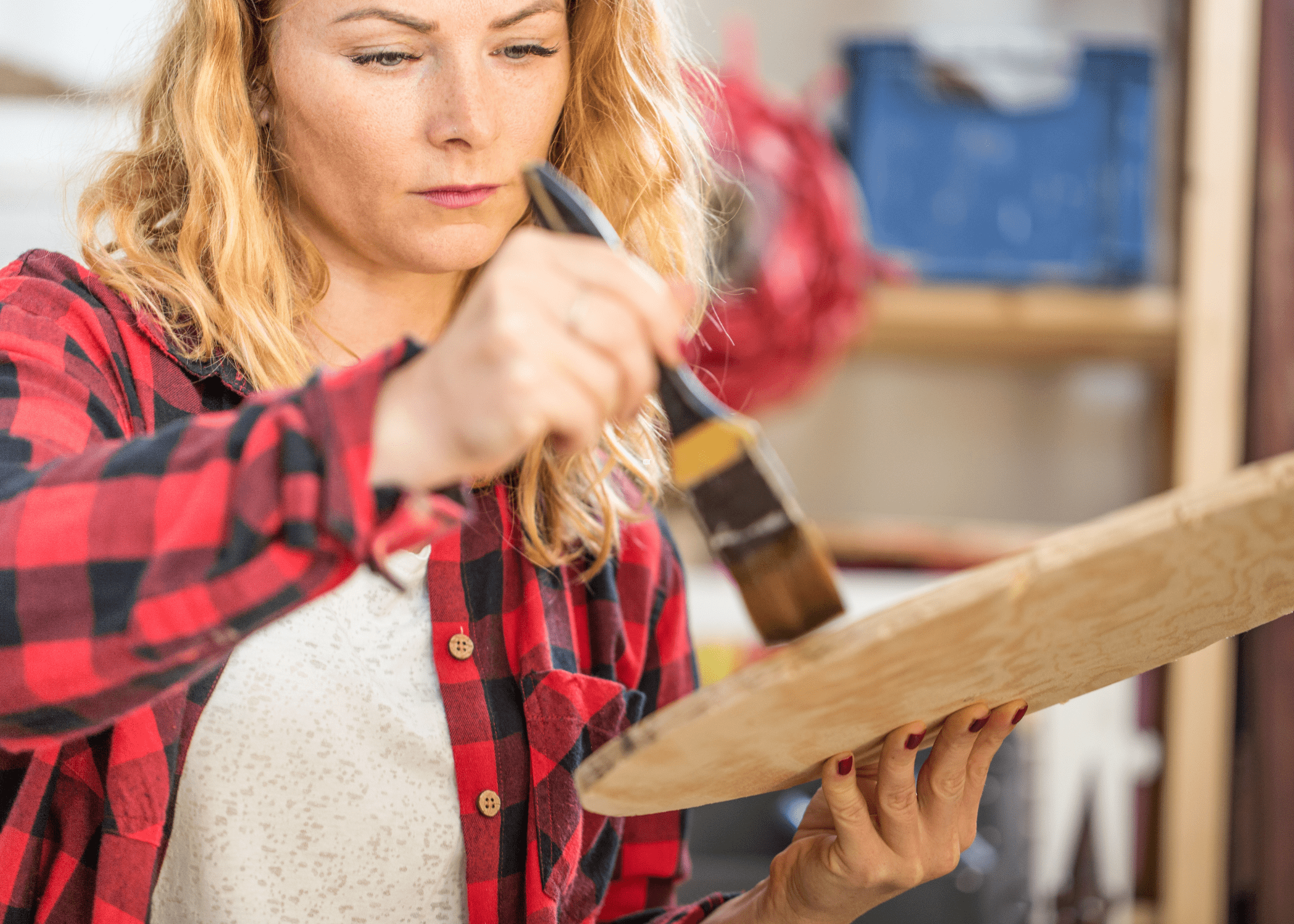 woman painting on a piece of wood