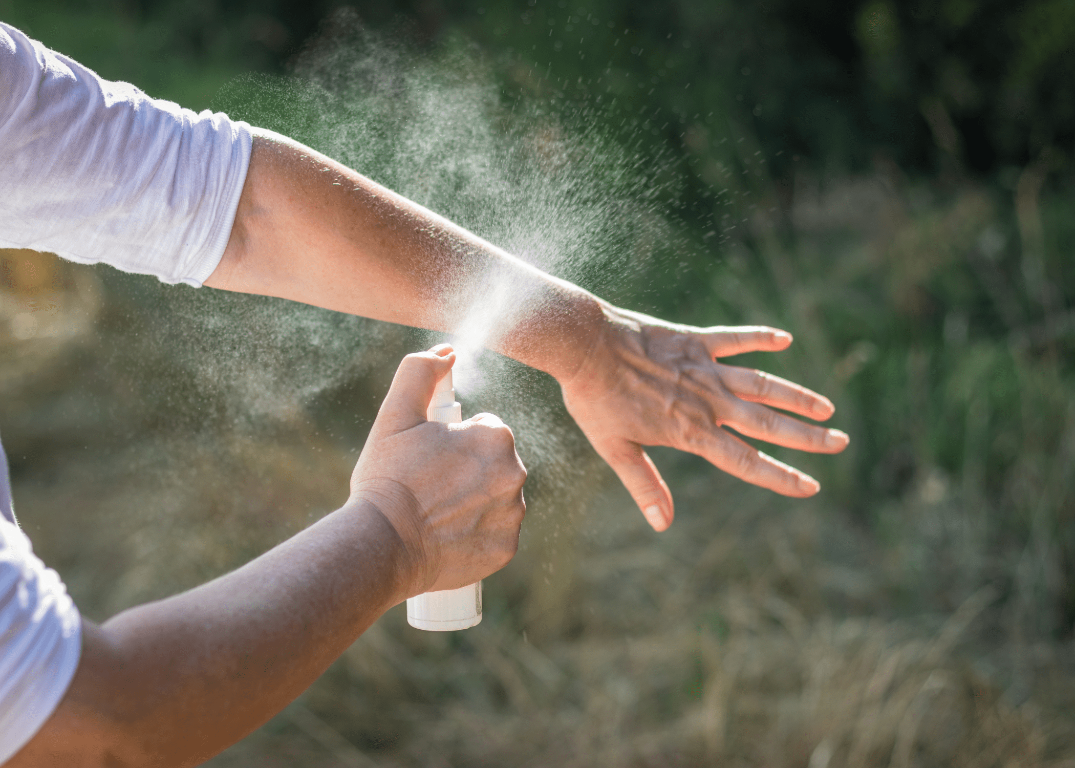 spraying spray on arm