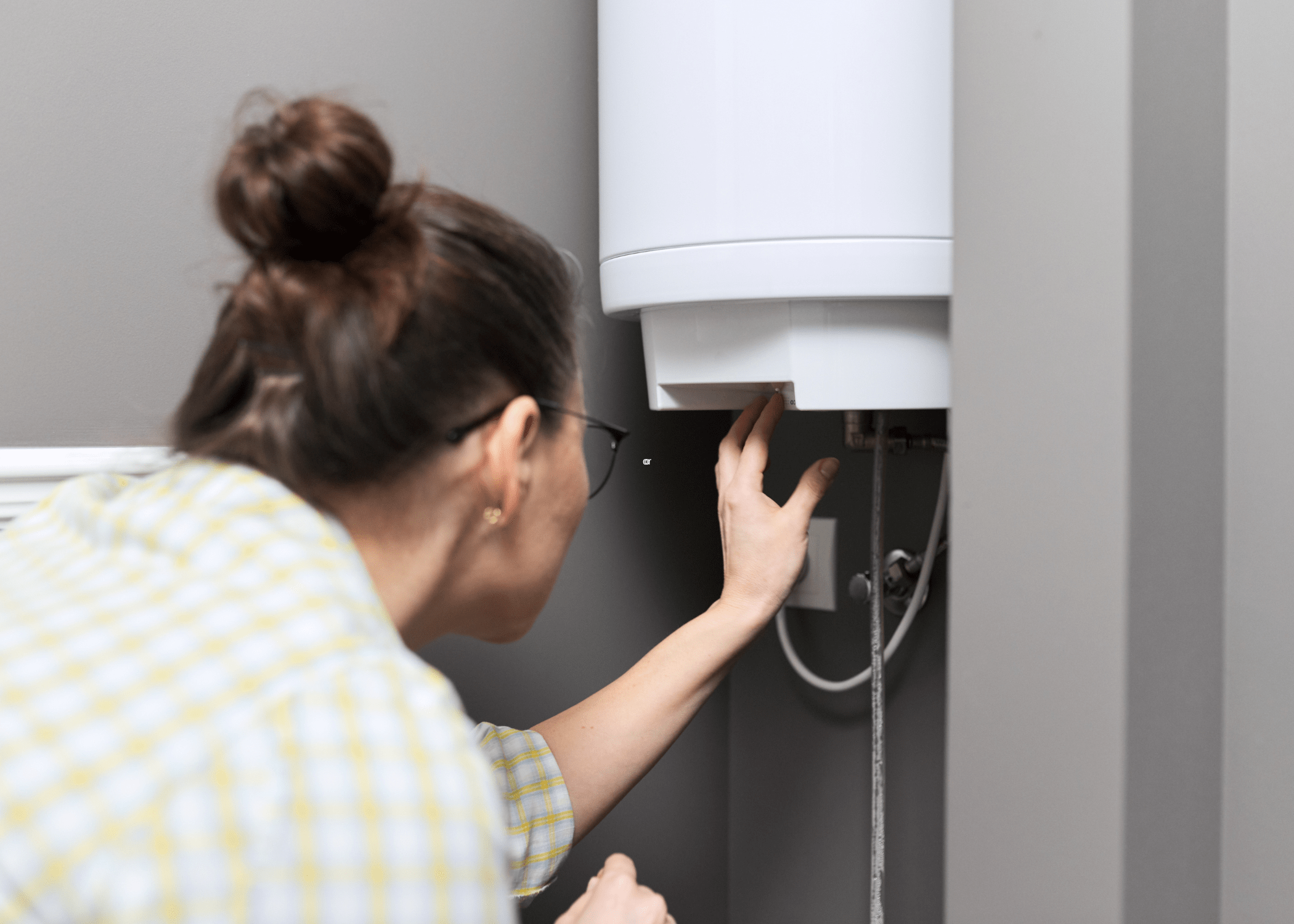 woman looking at tankless hot water heater