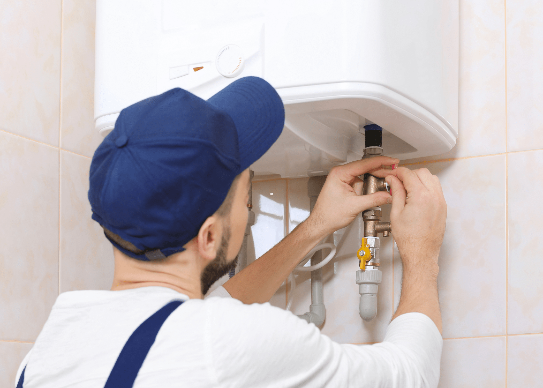 man working on tankless hot water heater