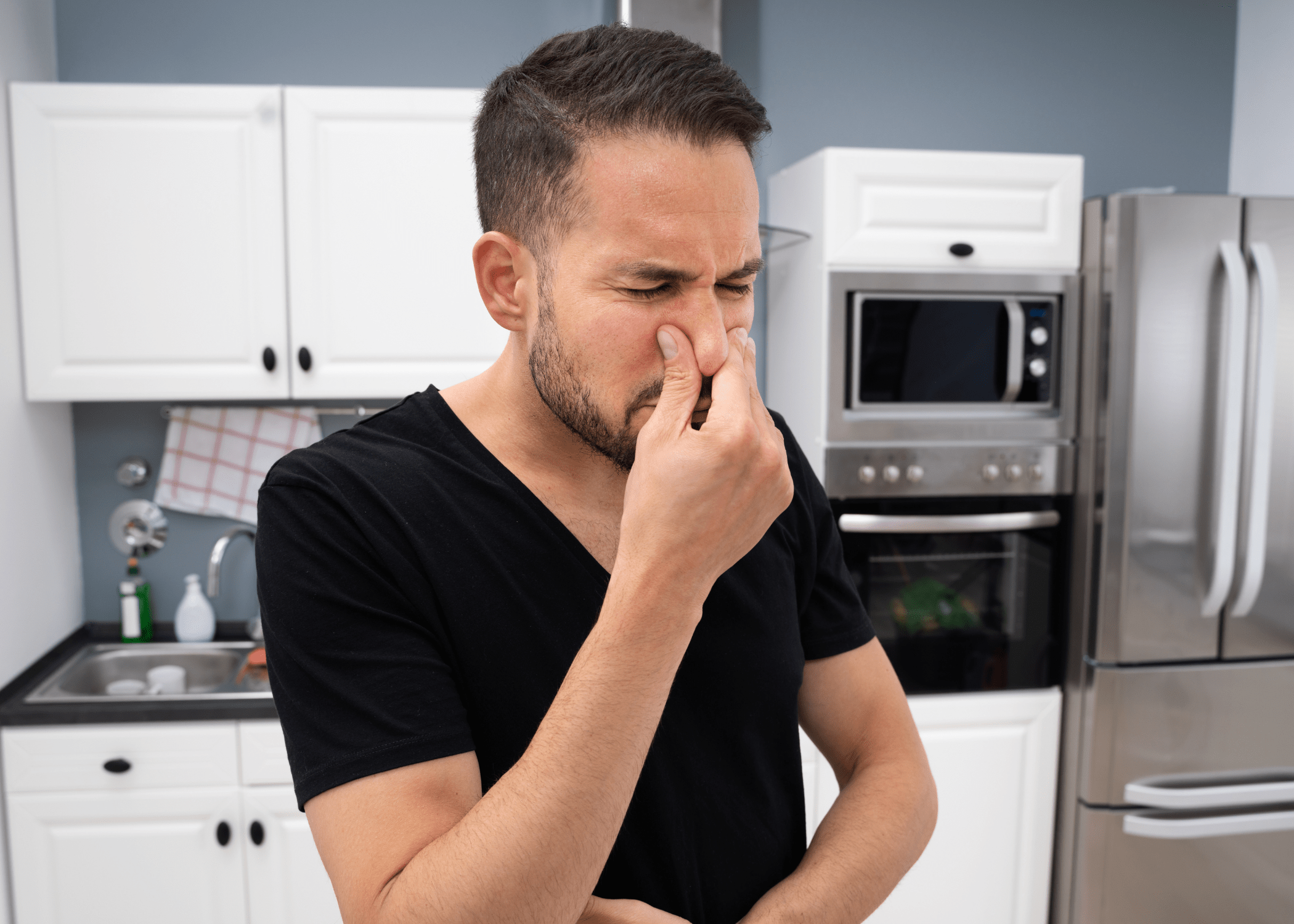 man holding his nose from bad smell