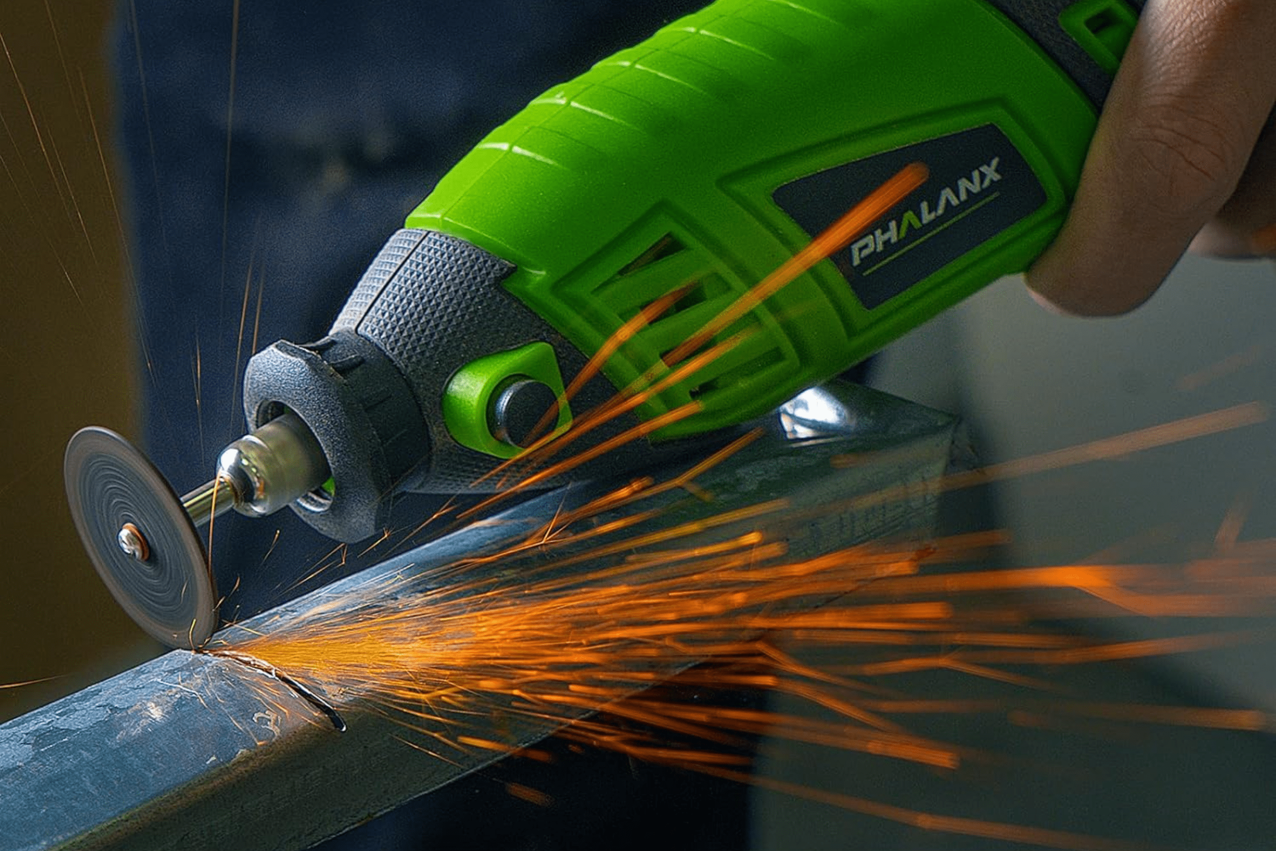 Green Dremel power tool cutting through sheet metal.