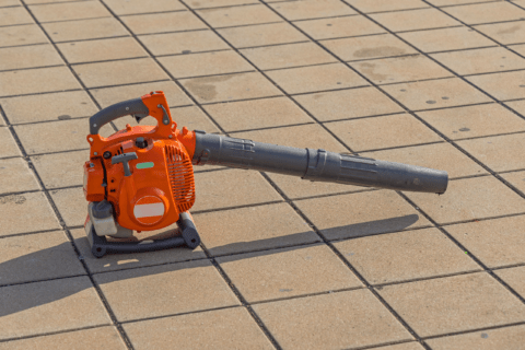 Leaf blower on concrete pavers.