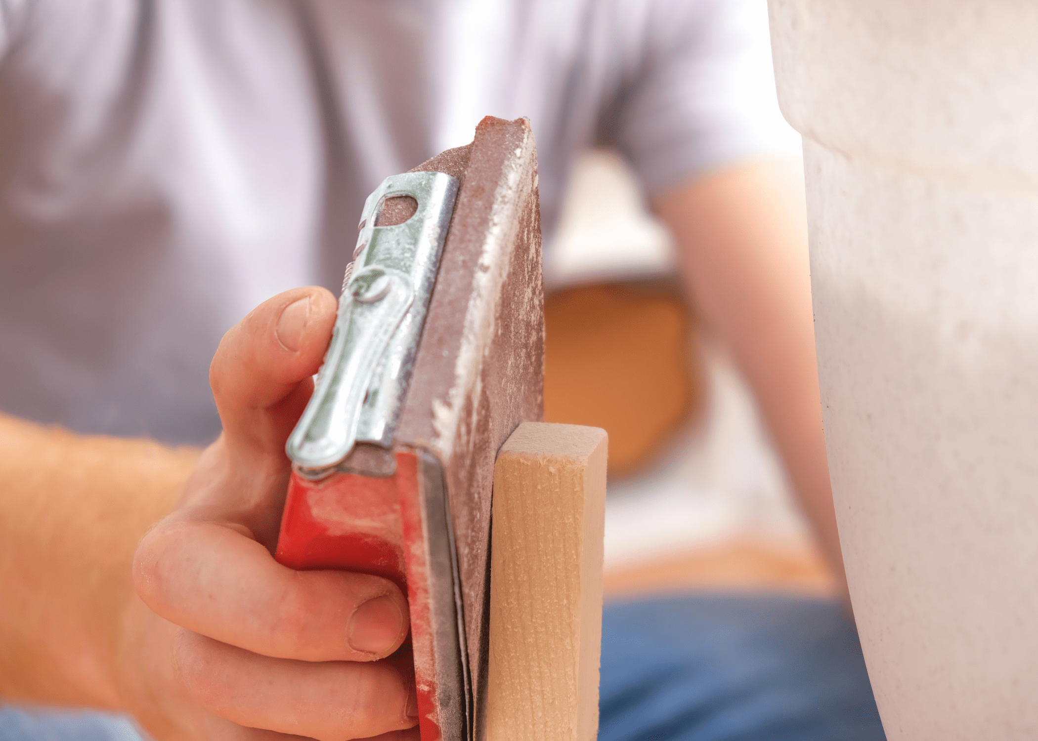 sanding down a piece of wood.