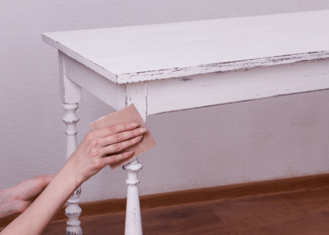 sanding down piece of distressed furniture