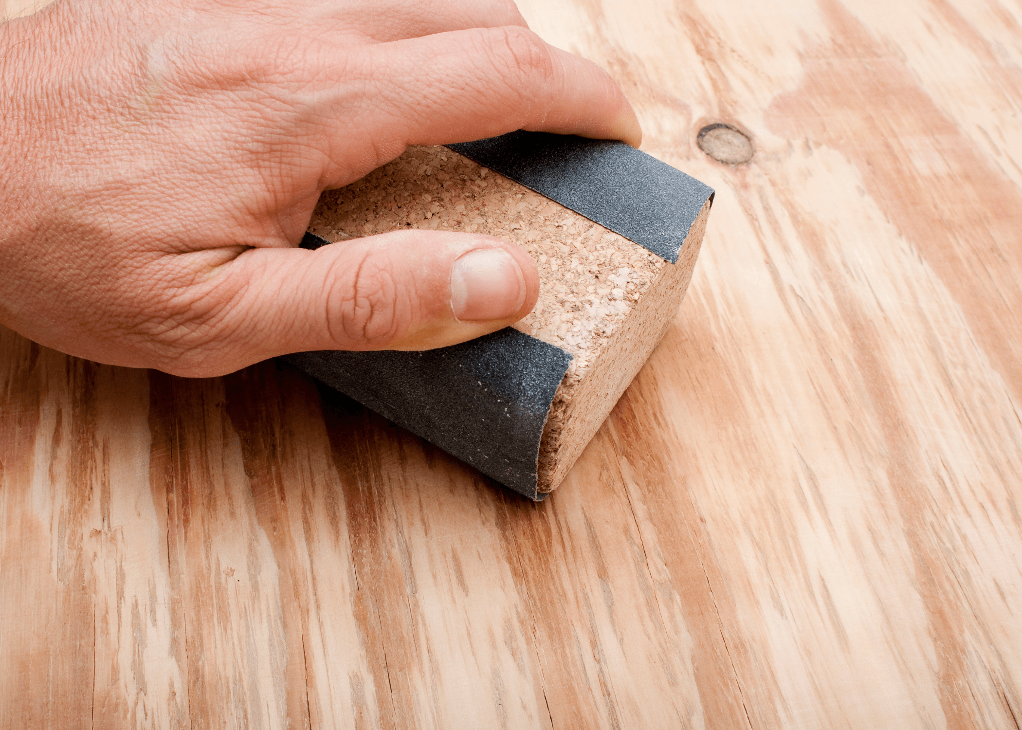 sanding a piece of wood.