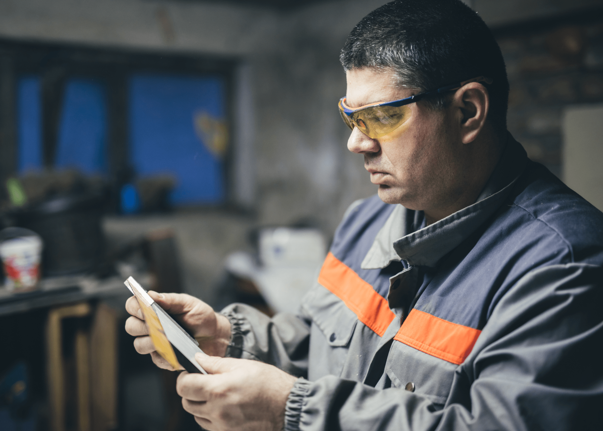 man sanding some tool with sandpaper.