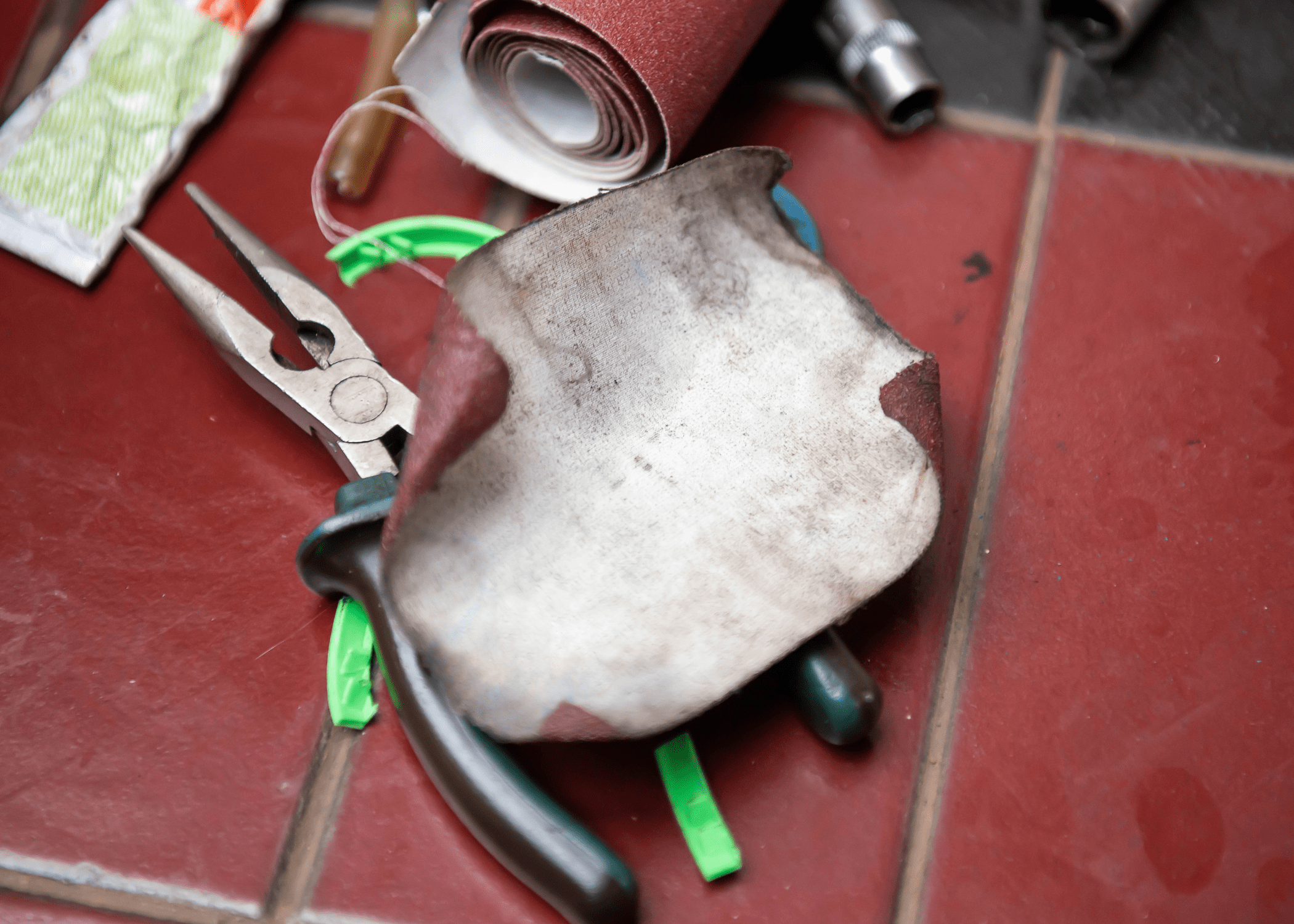 rusty tools with a piece of worn sandpaper.