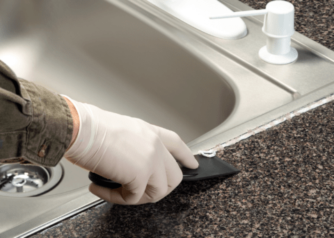 scraping off caulking around sink