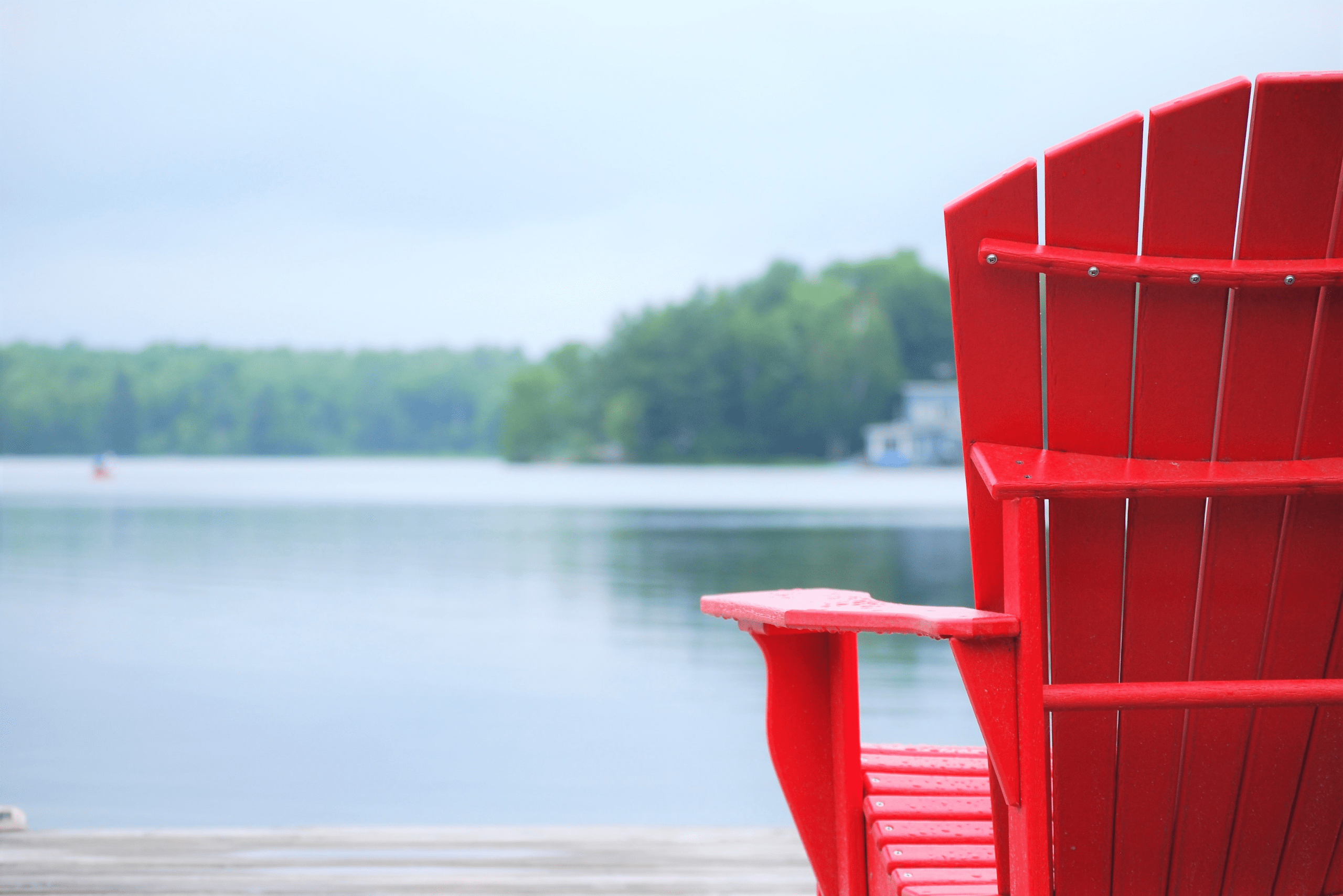 Rear view of a red Adirondack chair.