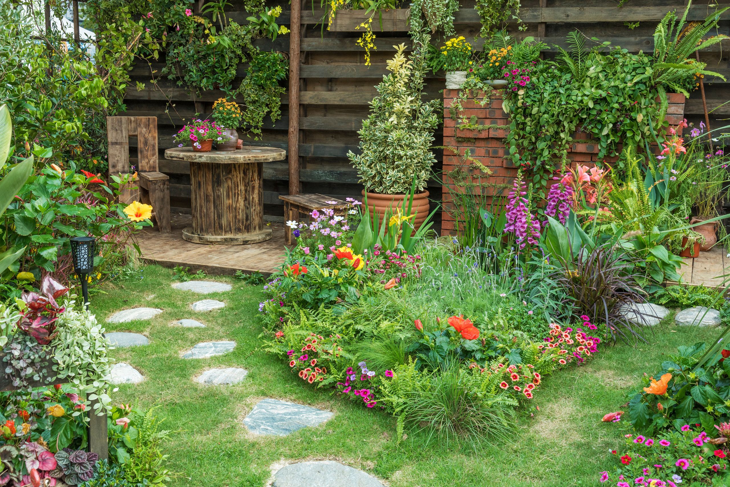 Green garden with stone walkway.