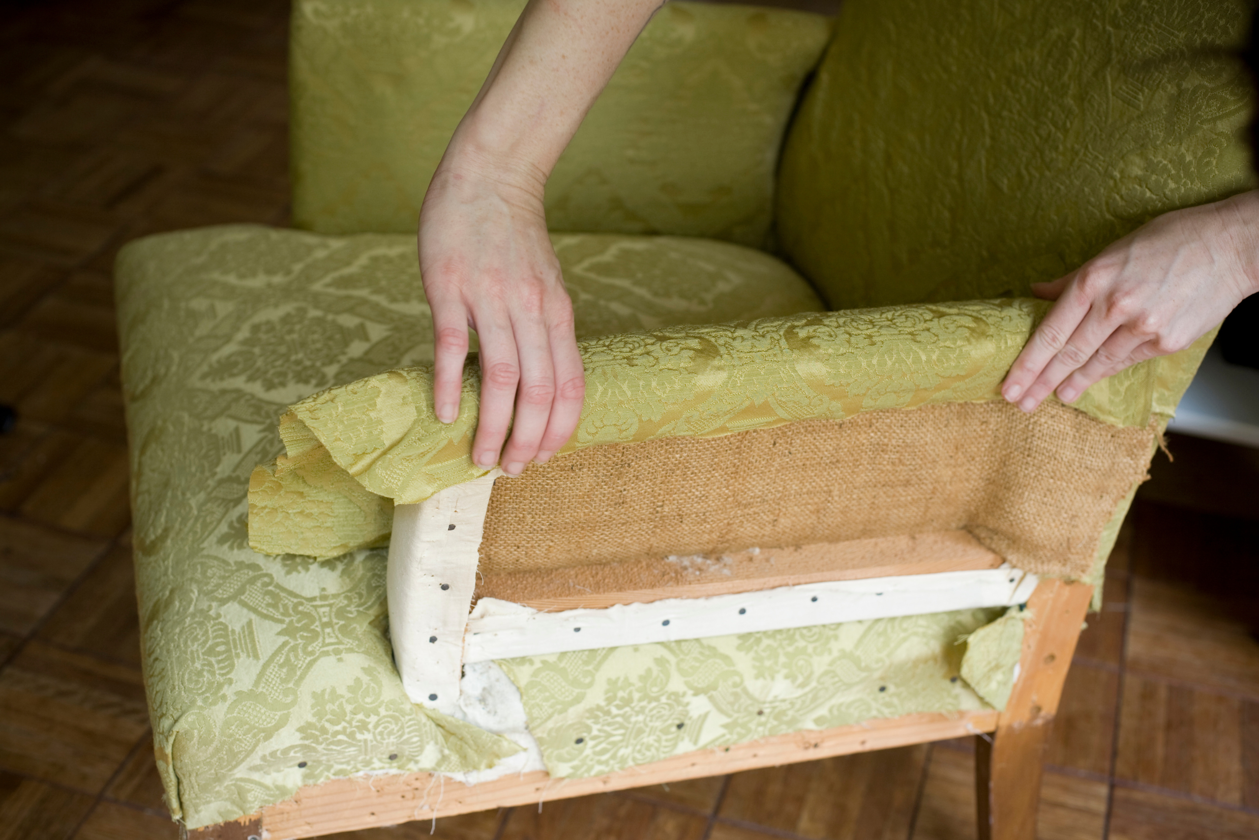 A person reupholstering furniture.