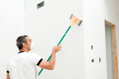 Man using sanding pole.