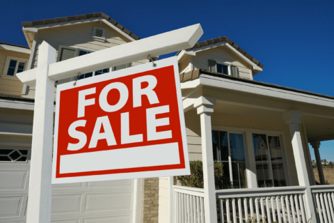 House with sign that reads 