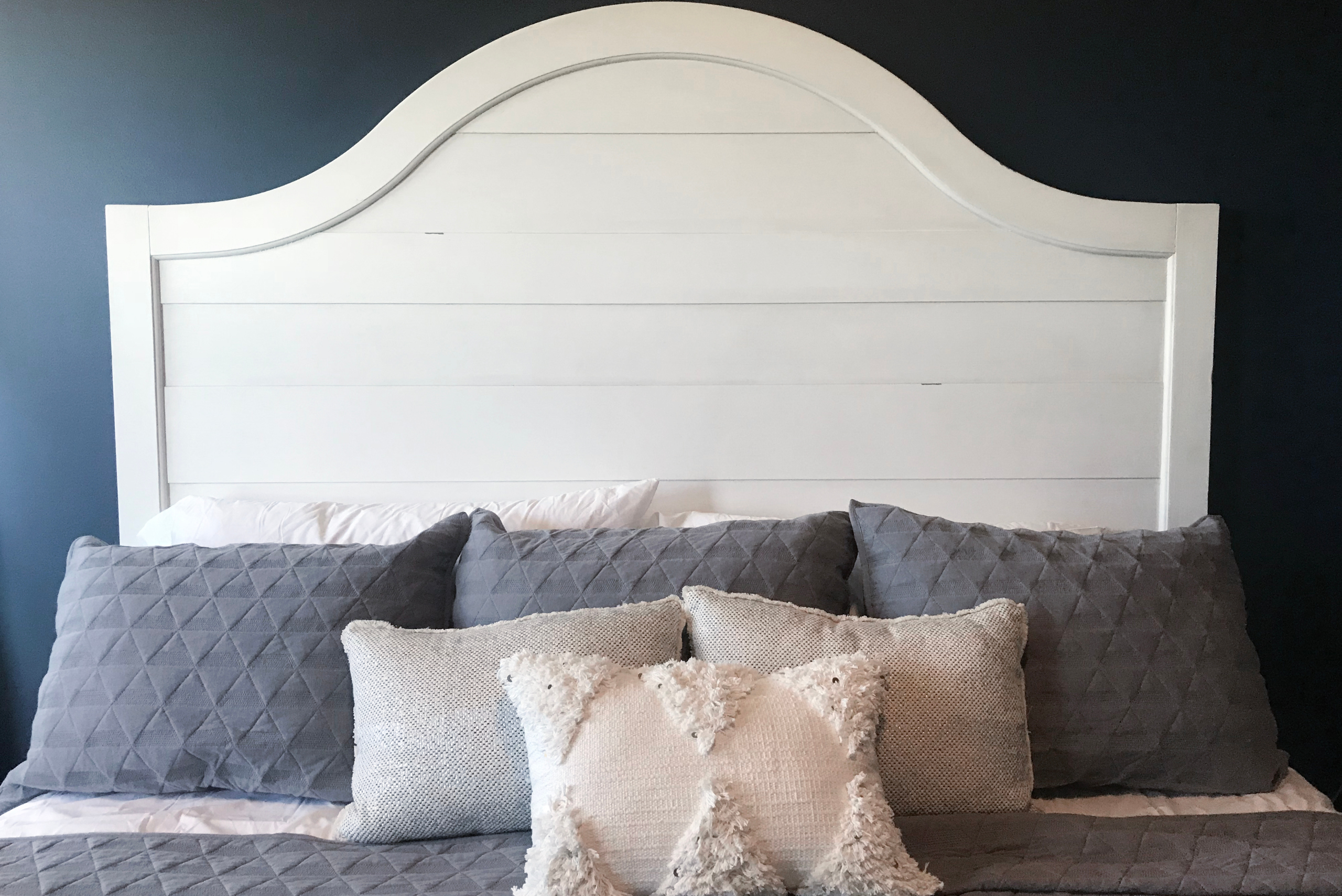 A wooden bed headboard.