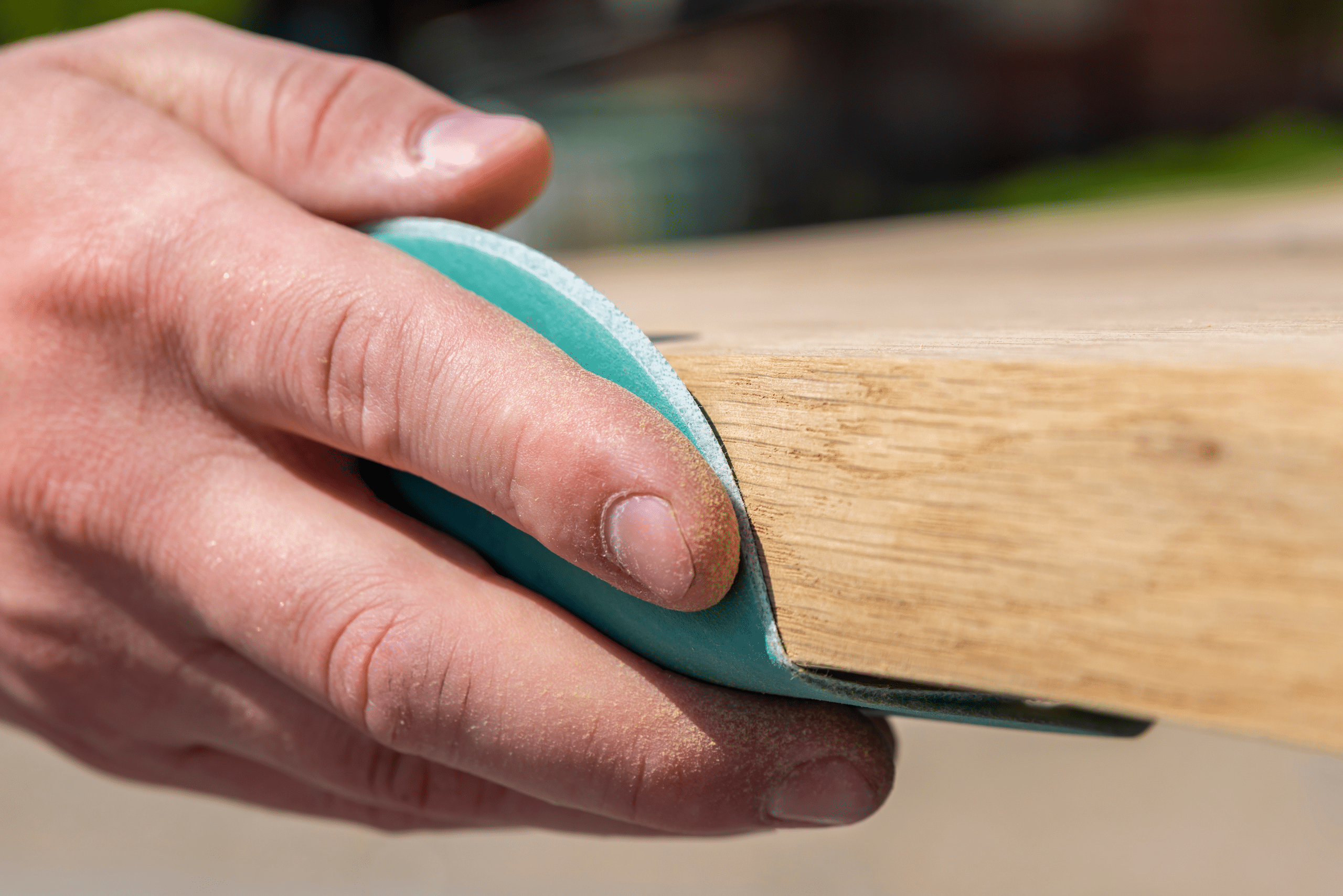 Sanding a piece of wood.