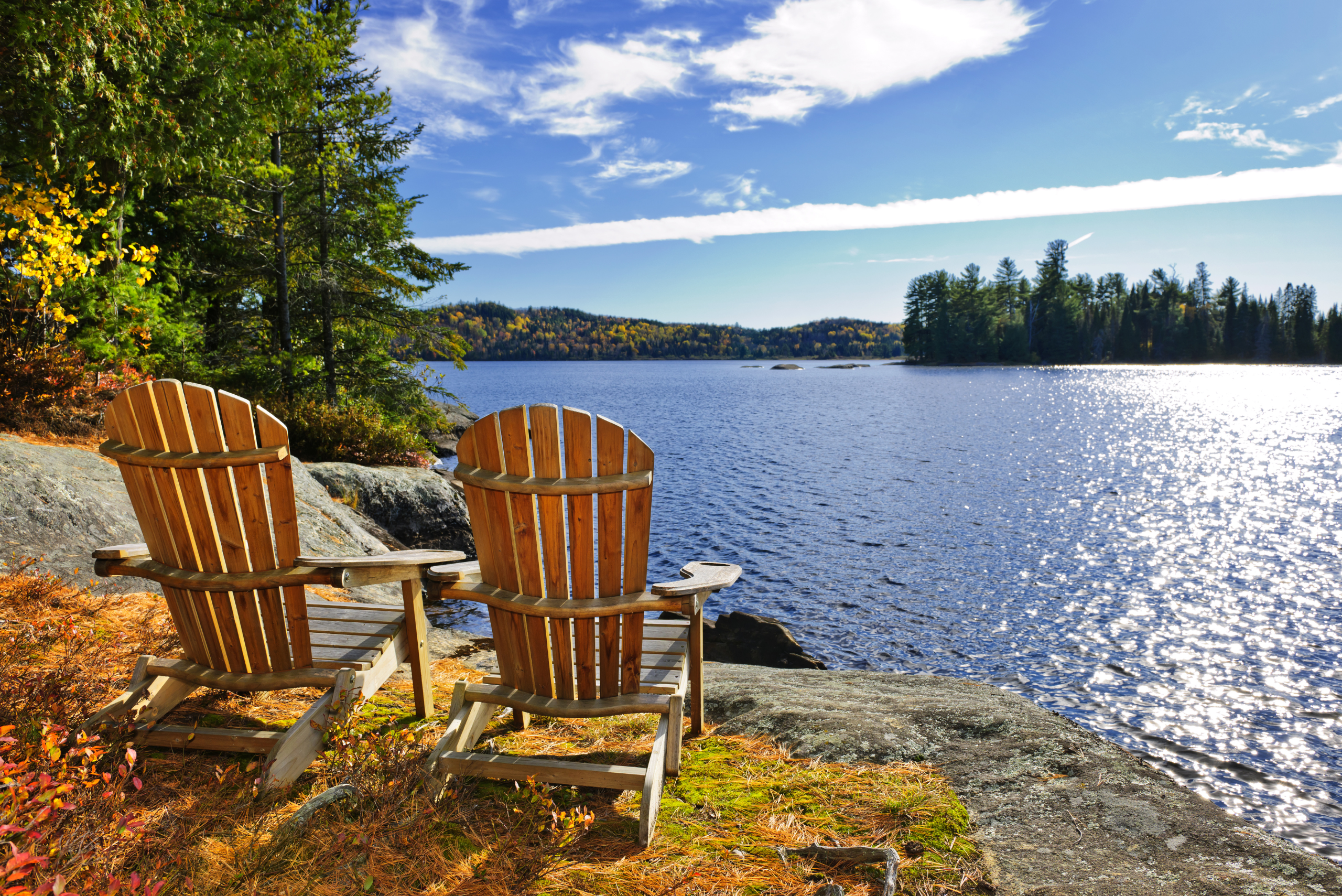 Adirondack chairs by the water.