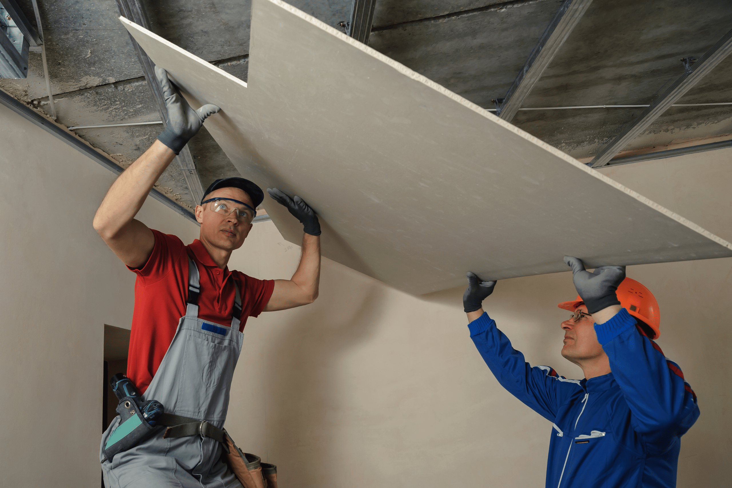 Two men installing drywall.