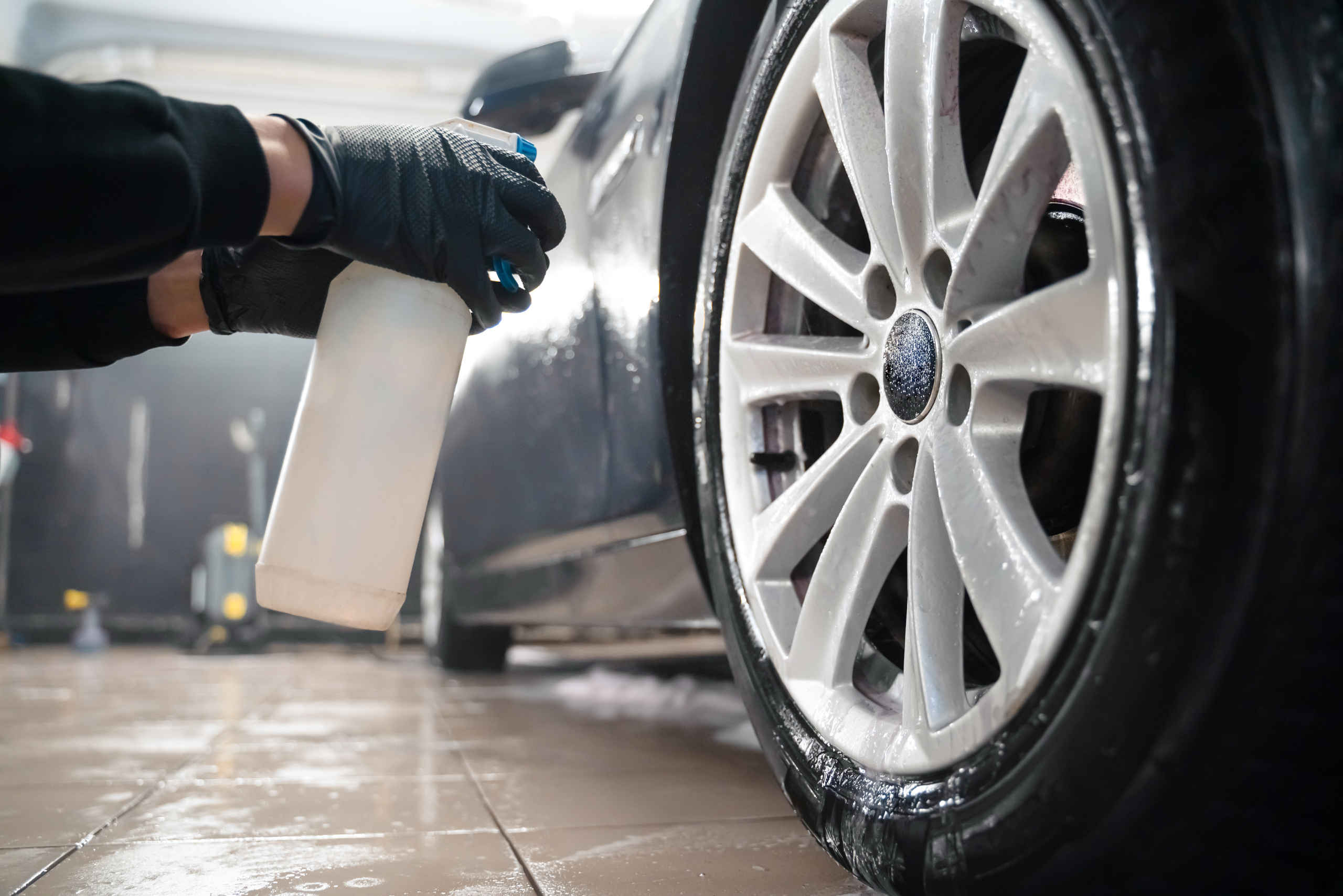 Spraying wheel with cleaning solution.