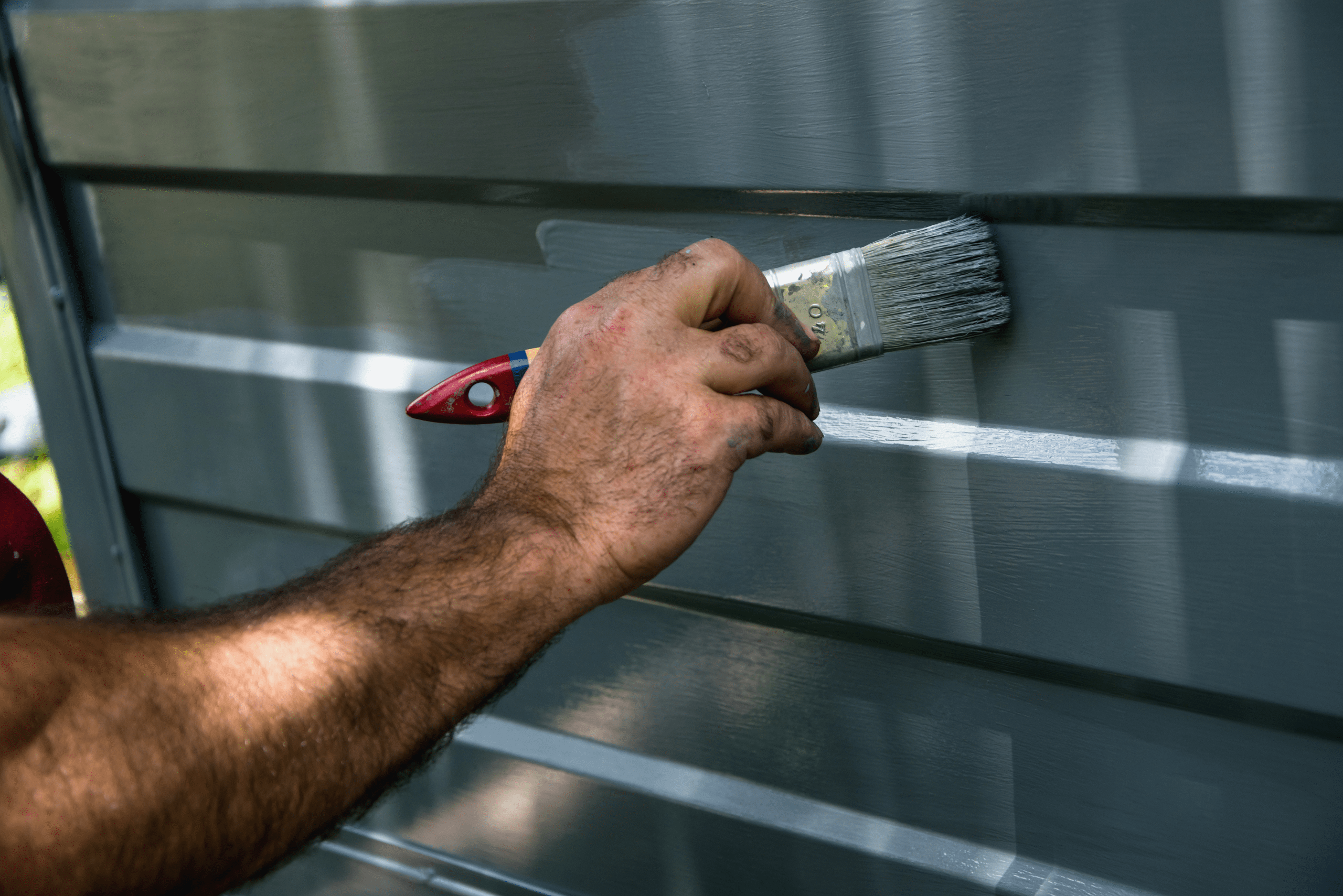 Person painting garage door.