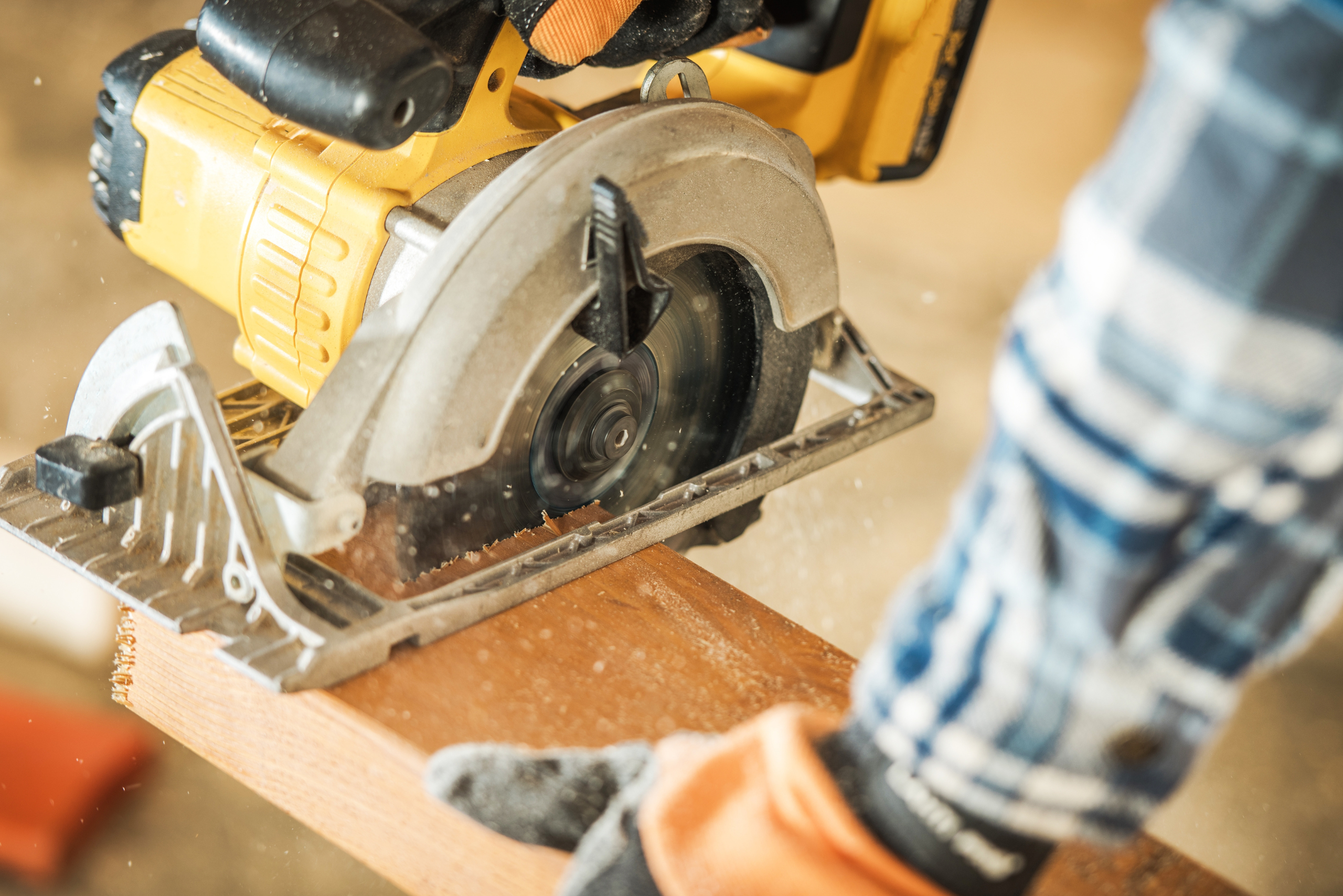 Cutting wood with power saw.