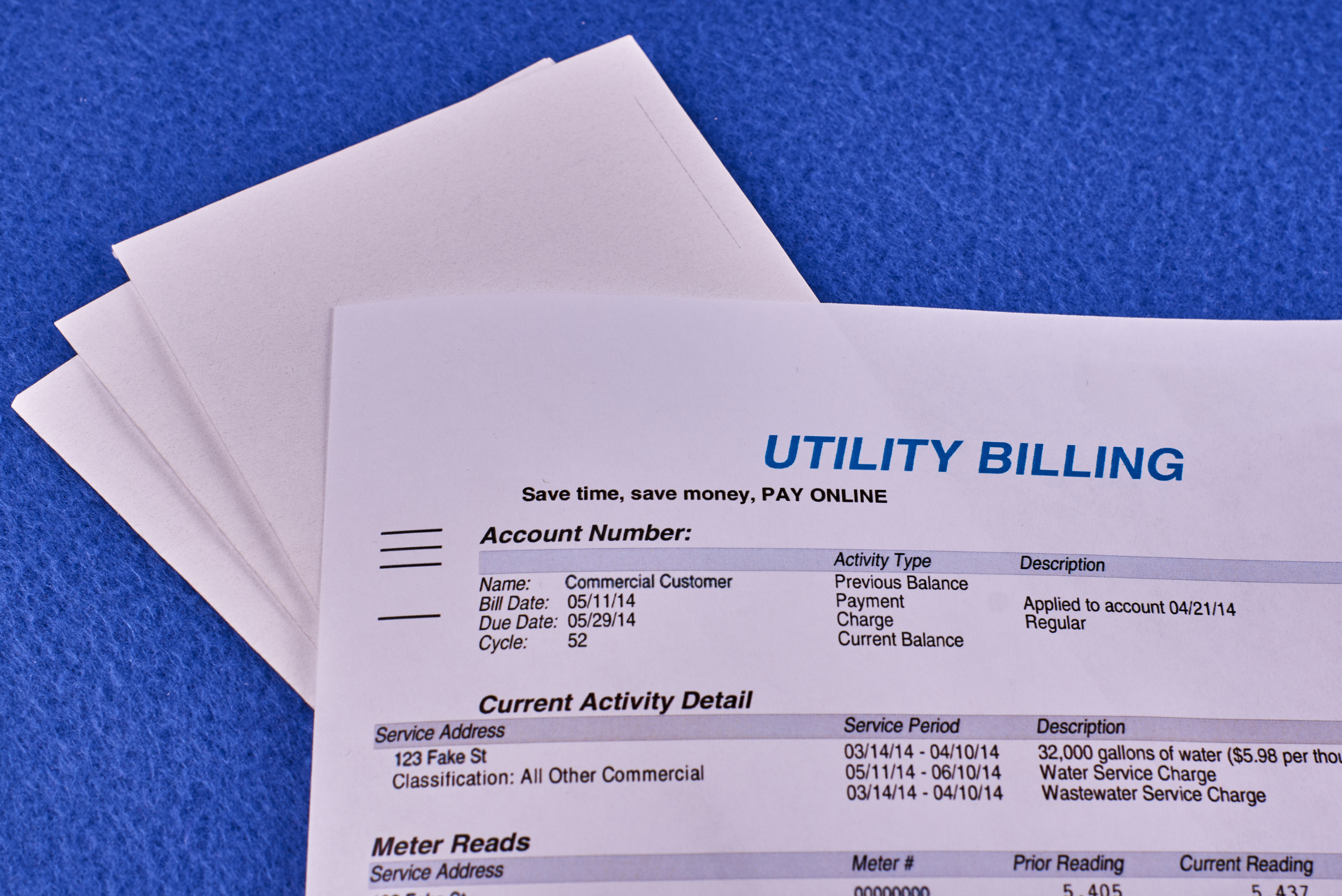 Utility bill papers on blue background.