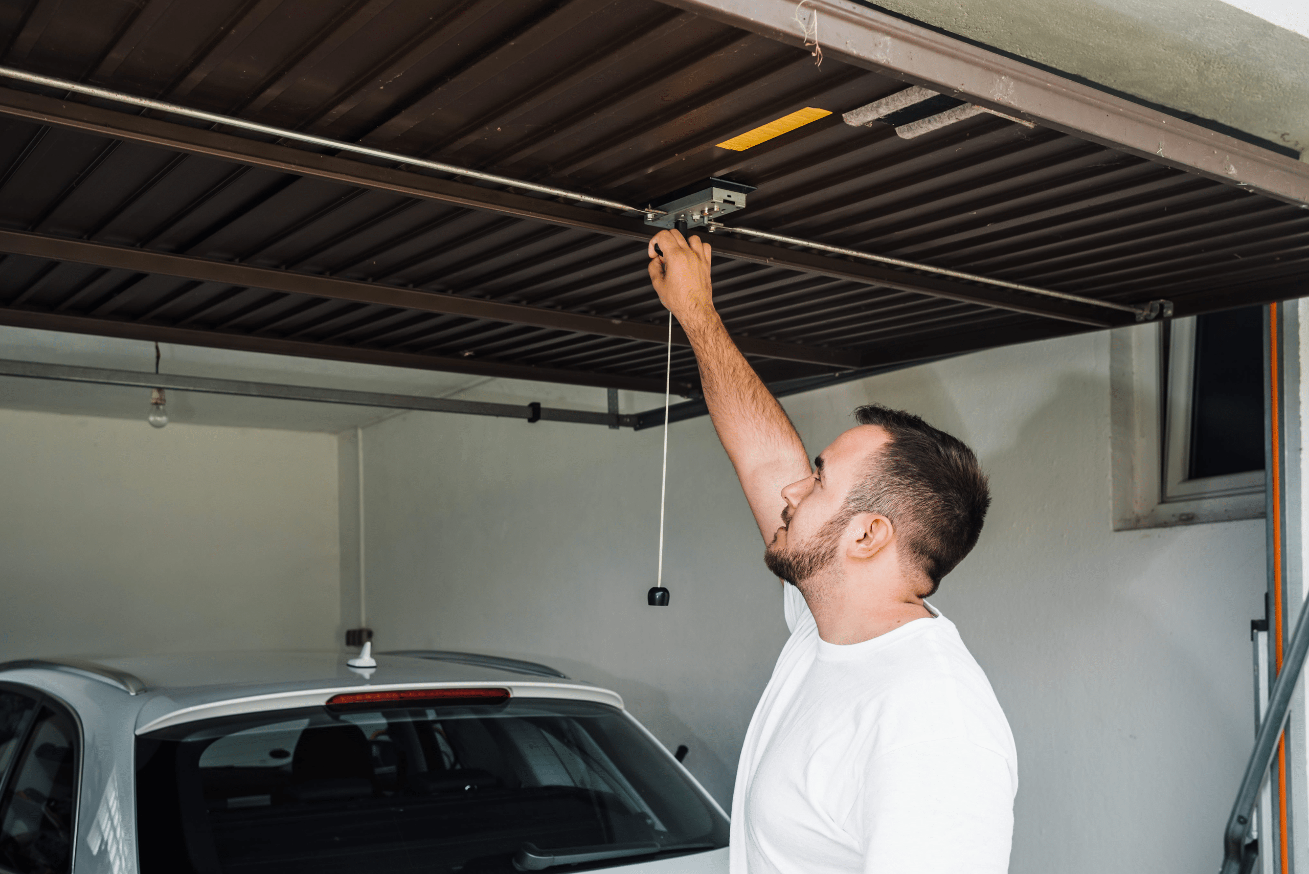 Man closing reinforced garage door.