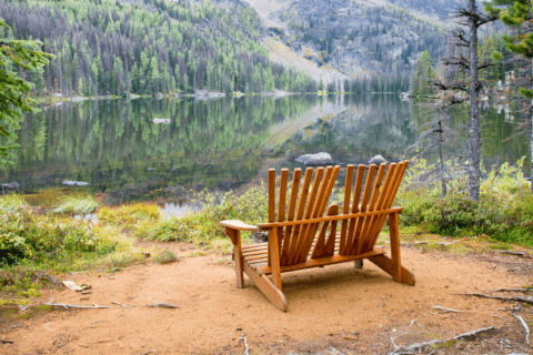 Adirondack chairs facing the water.