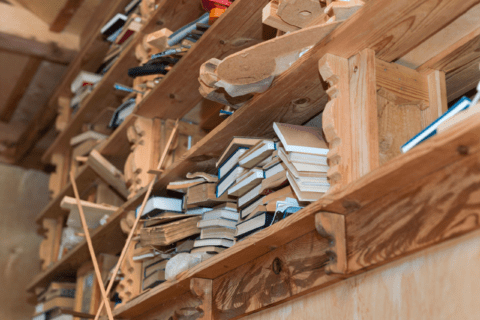 A wooden shelf full of books.