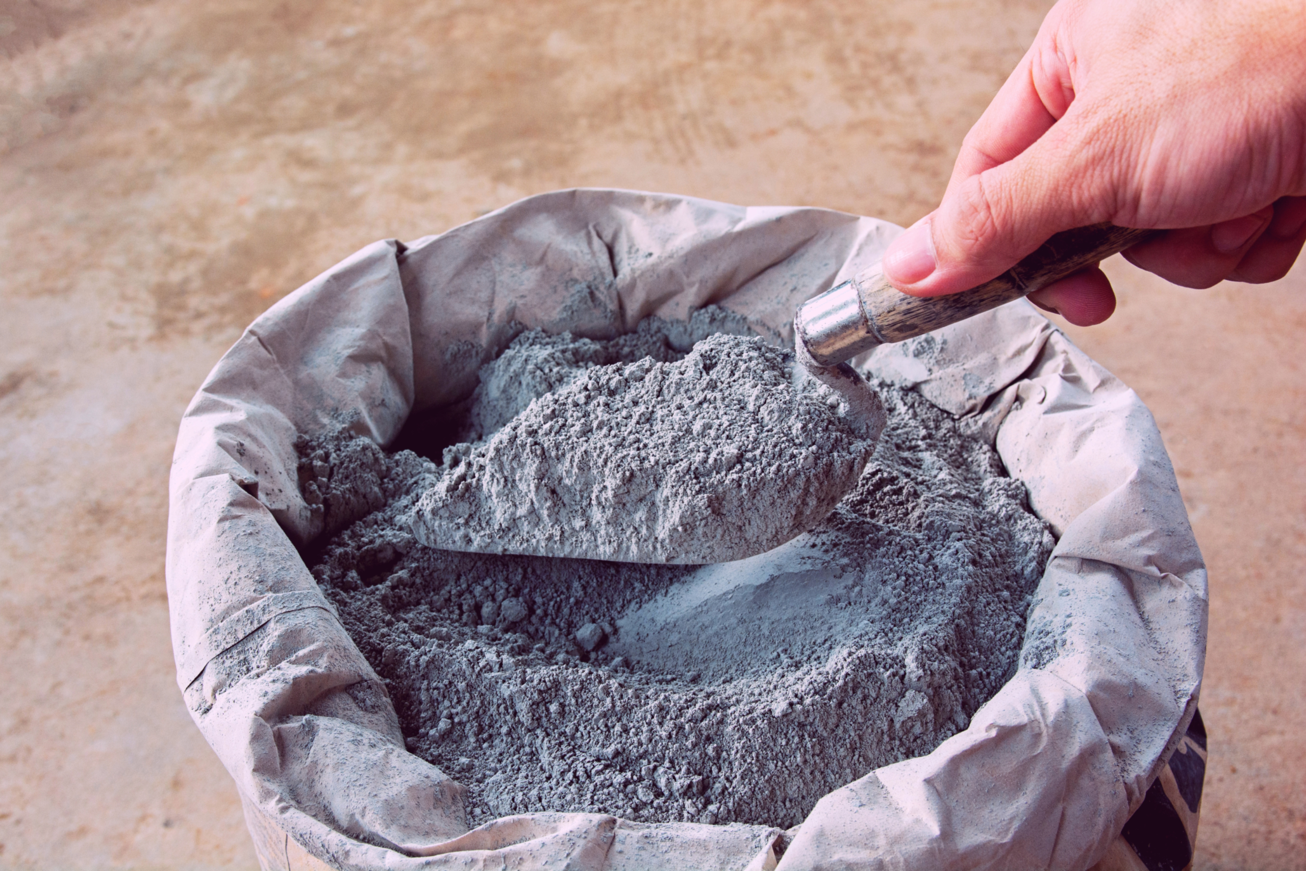 Cement bag with person pulling some out.