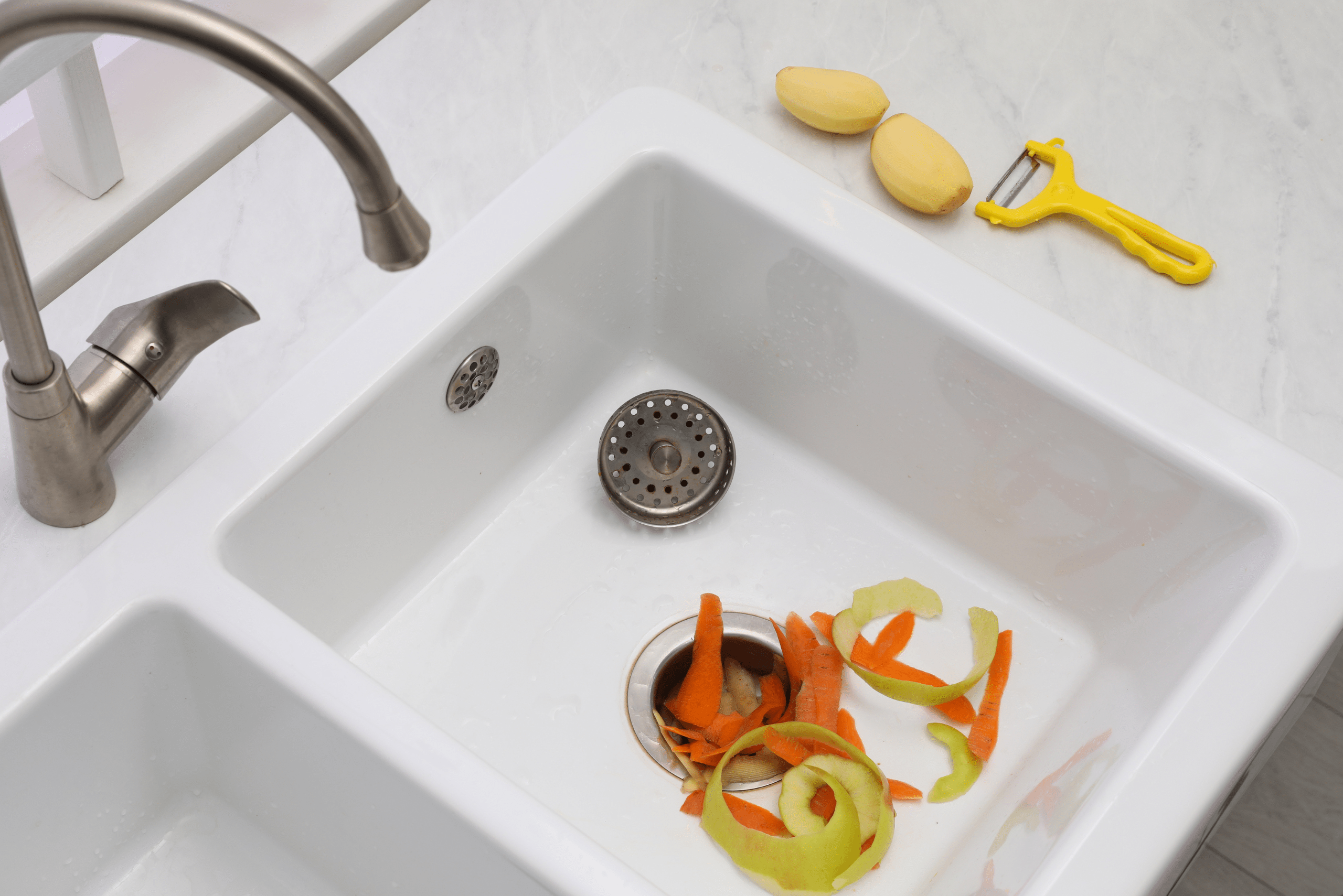 Sink garbage disposal full of peels.