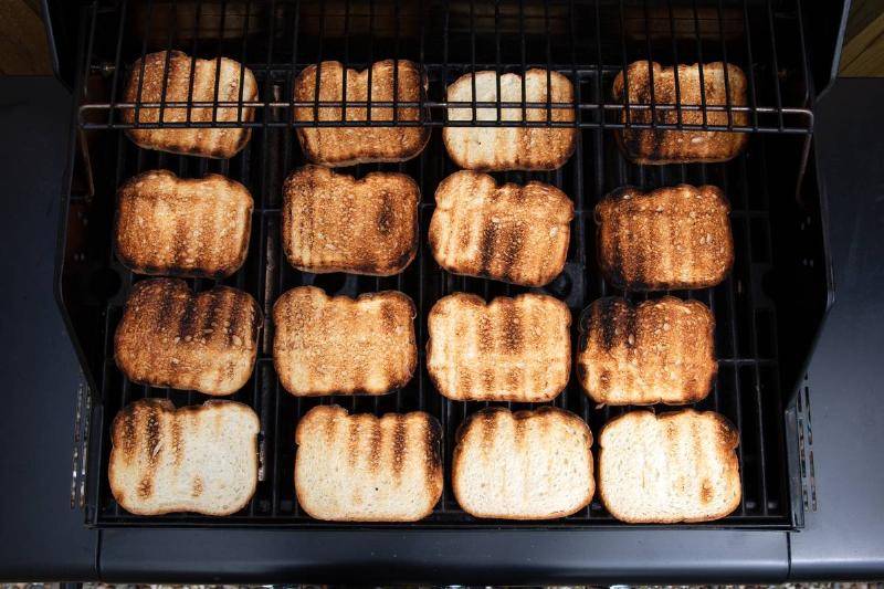 Buns being cooked on grill.