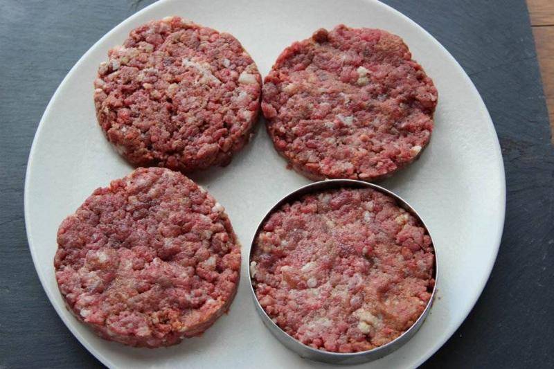 Round burgers on plate.