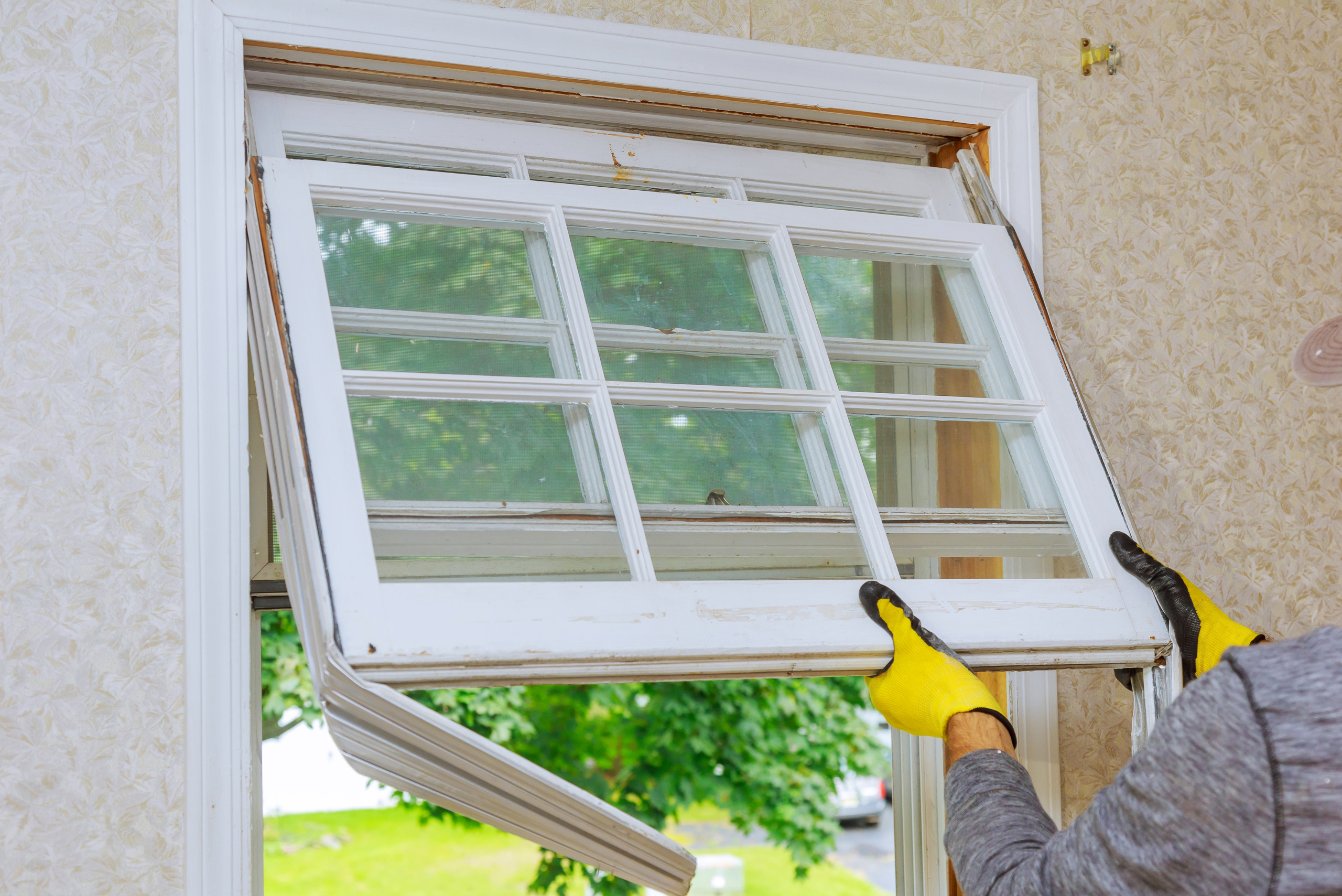 Worker opening window upwards.