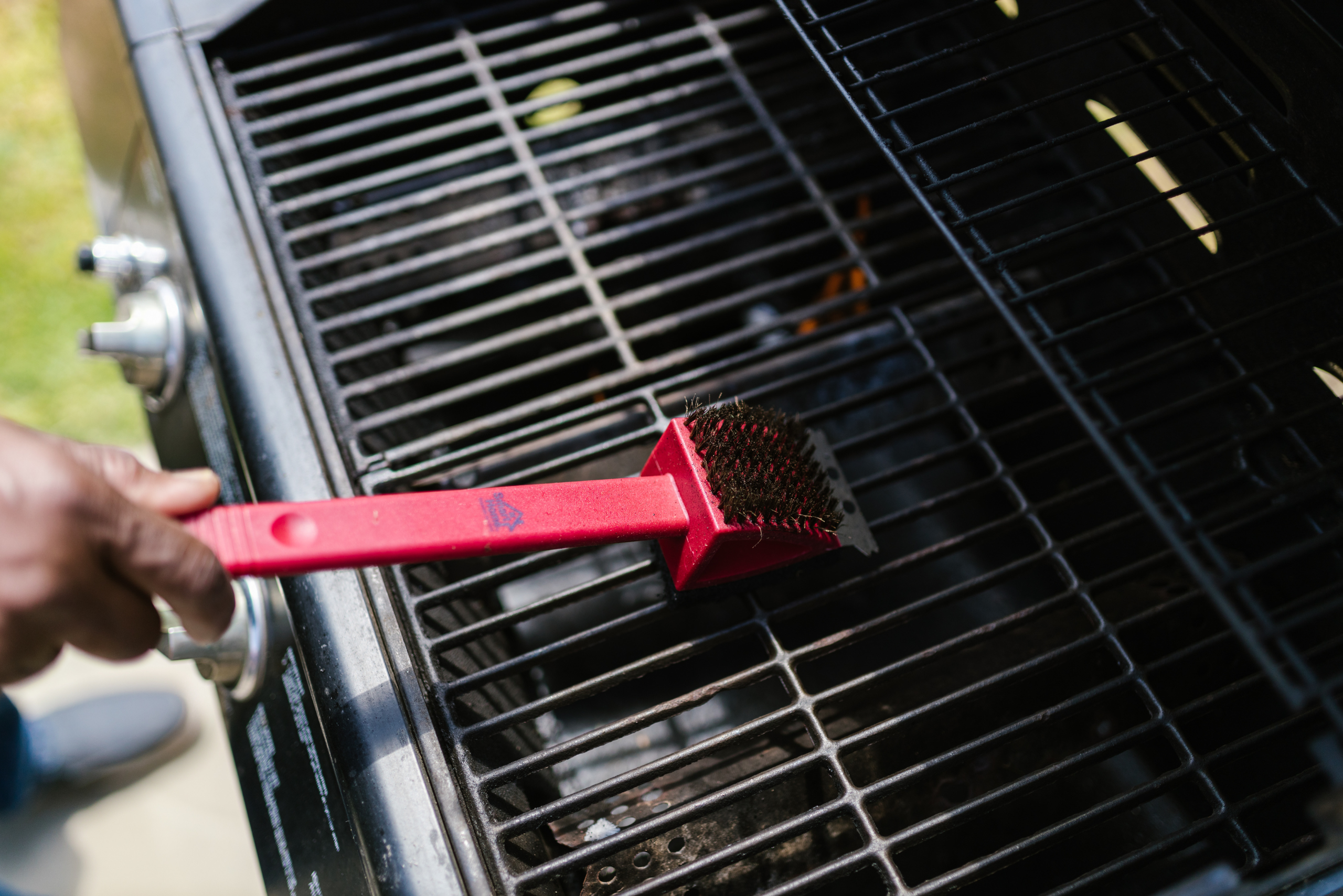 Red brush on grill of a BBQ