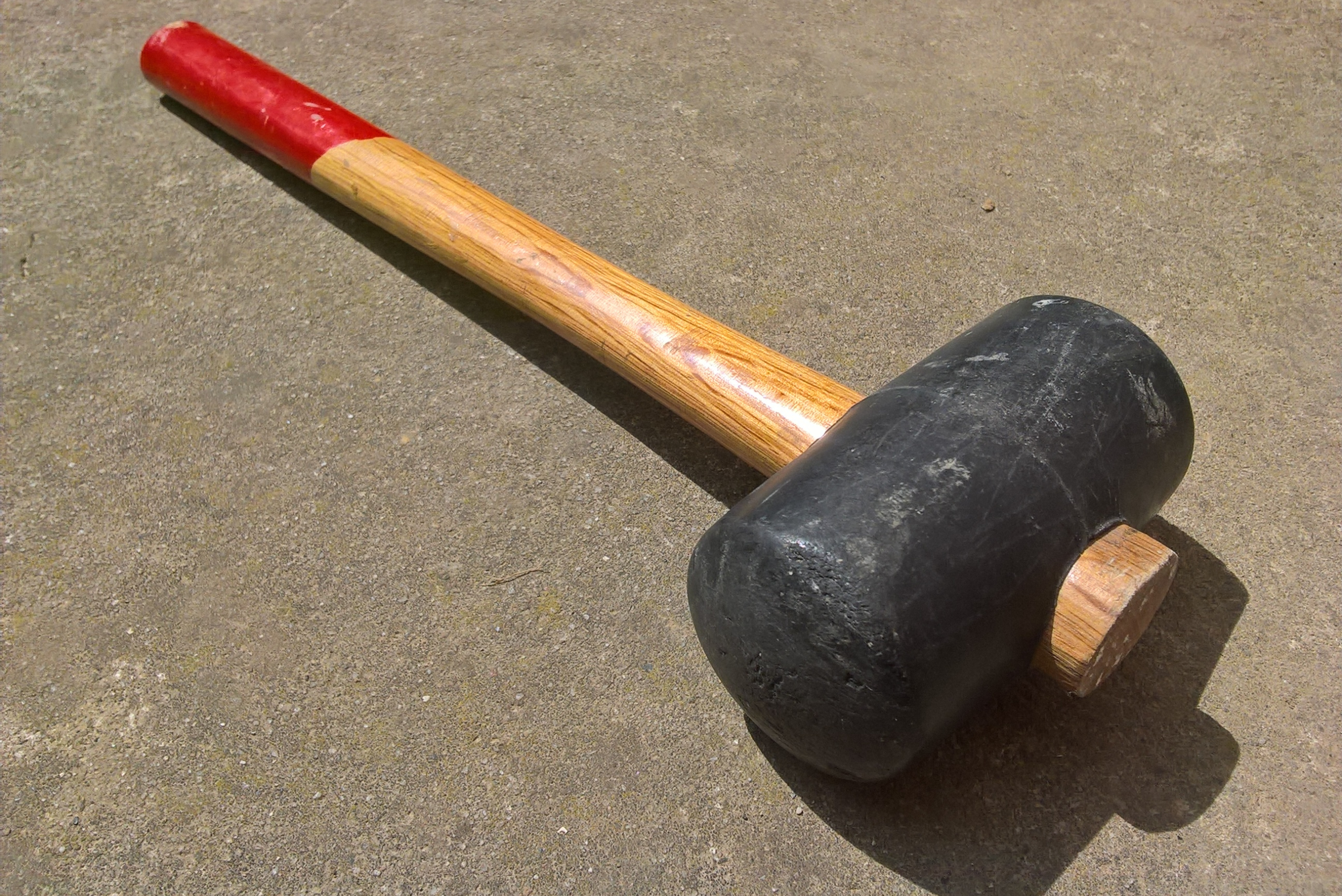 Rubber mallet on the ground.