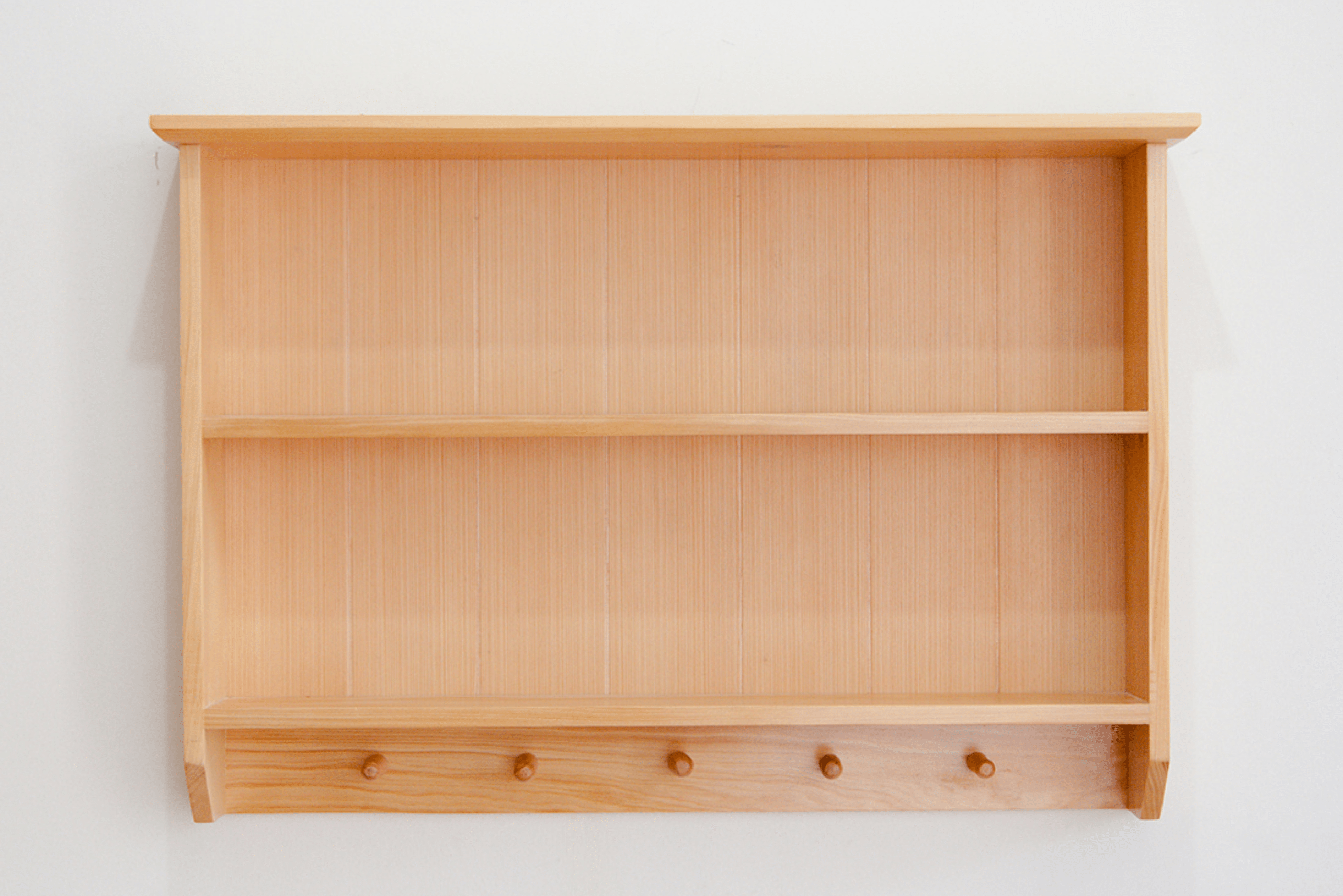 Multiple level wooden shelf with knobs for hanging coats.