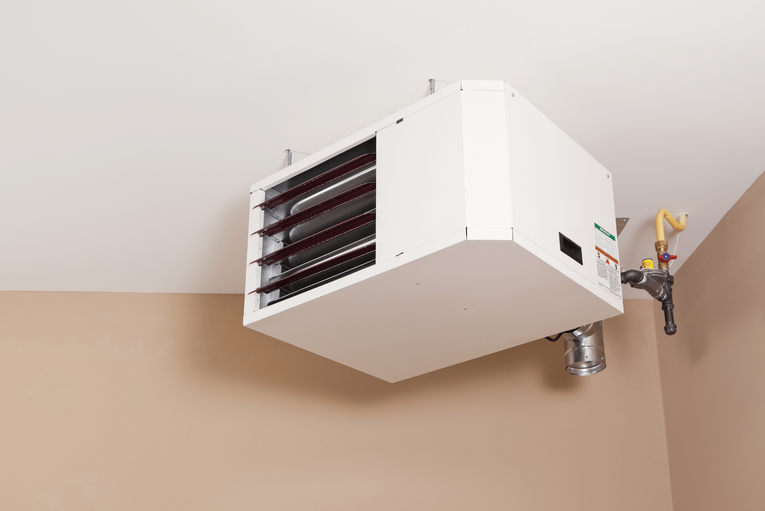 Forced air heating unit mounted onto the wall.