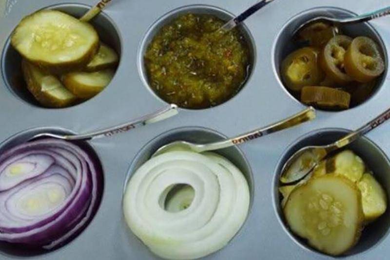 Using a muffin tray to hold condiments.