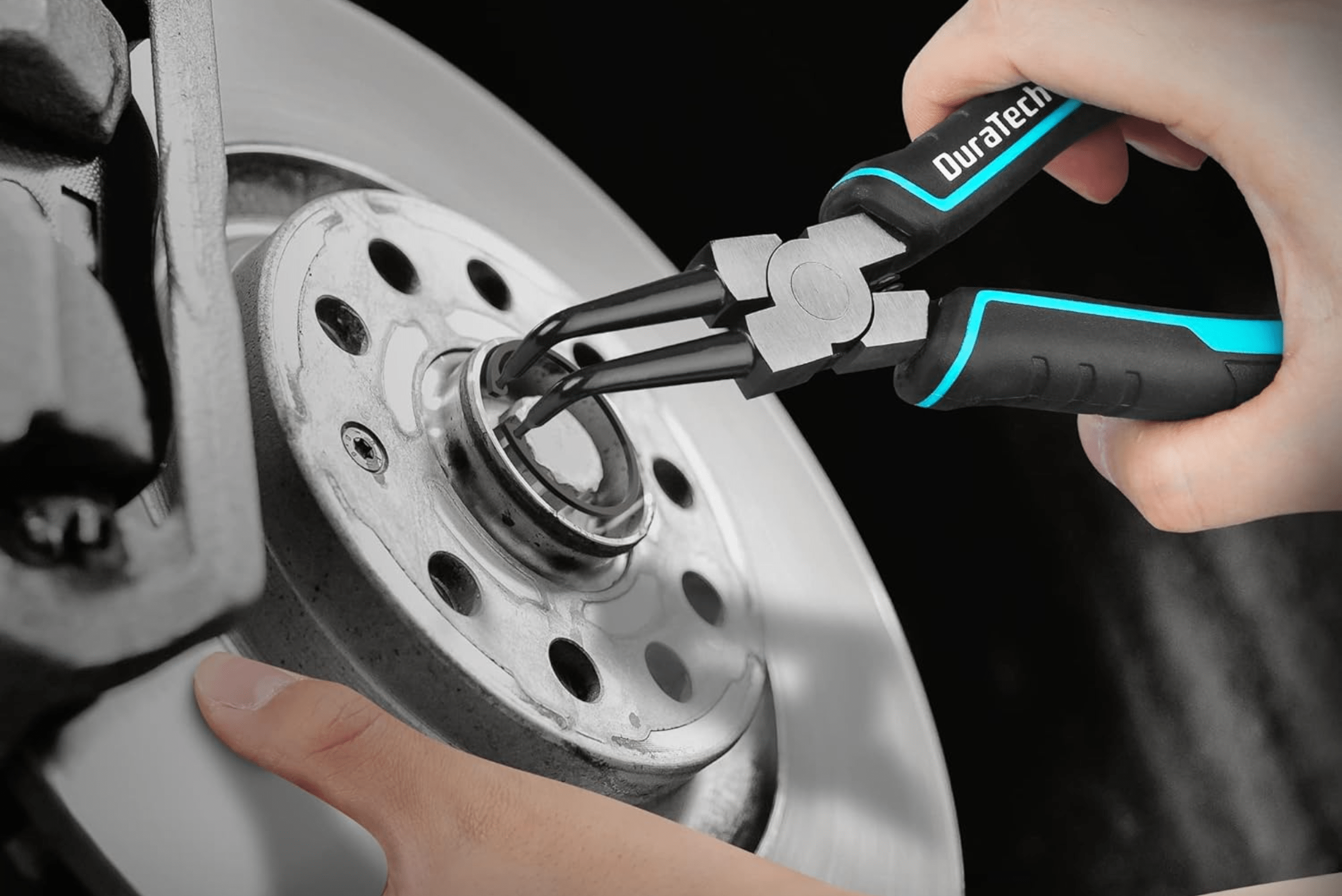 Person installing snap ring into a brake rotor using snap ring pliers.