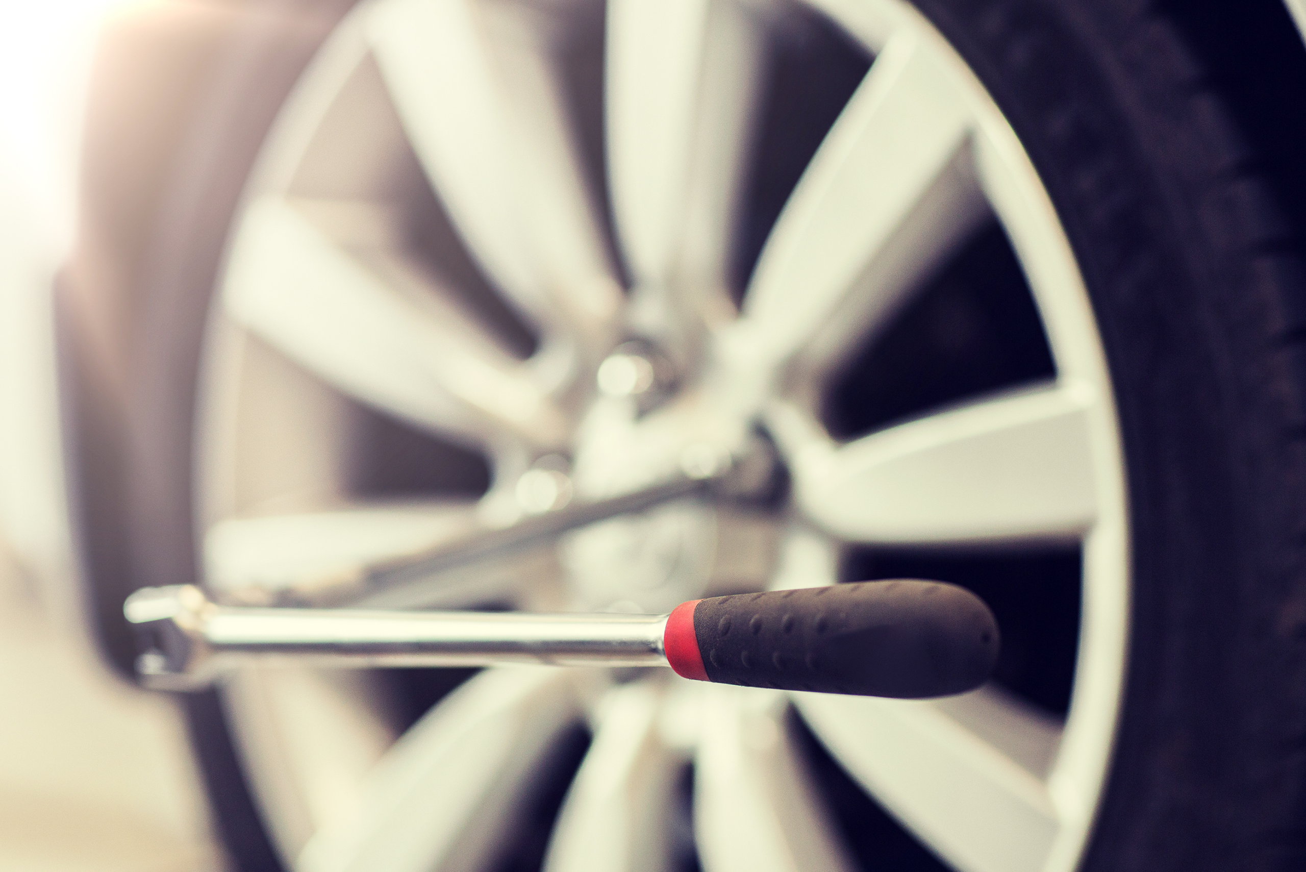 Breaker bar on a vehicle's lug nut.