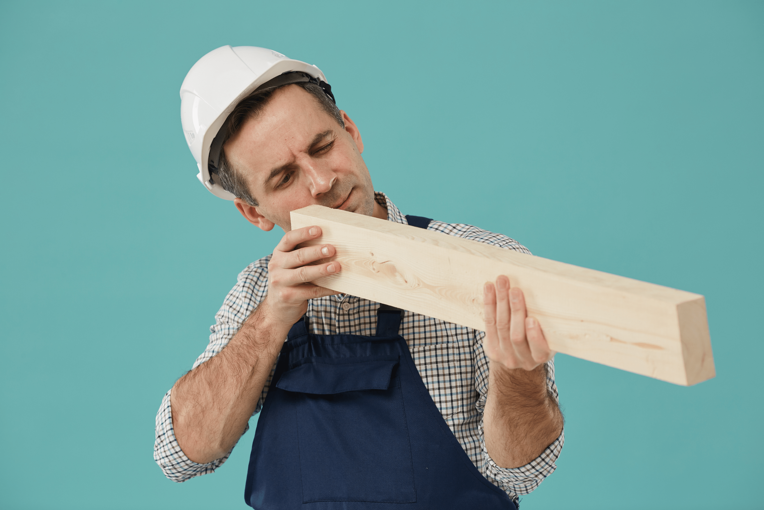 Worker inspecting wooden board.