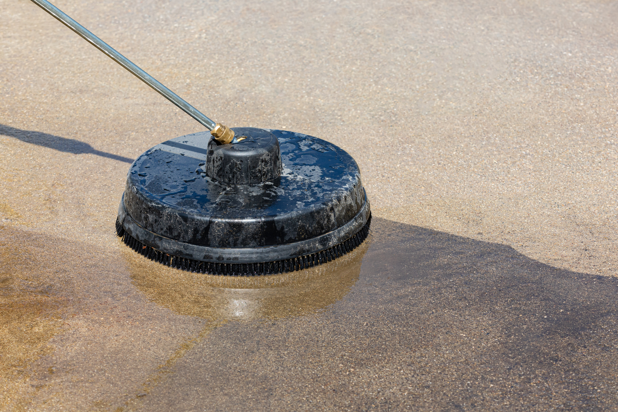 A concrete cleaner attachment on driveway.