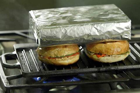 Brick wrapped in foil on top of sandwiches