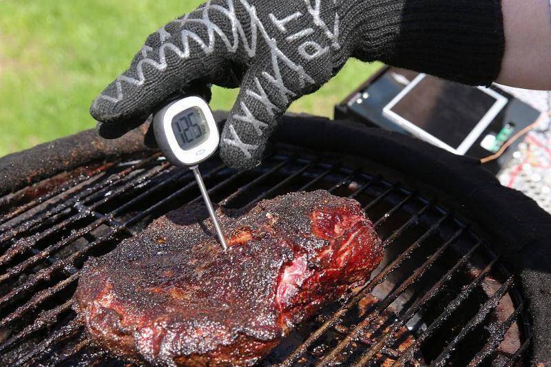 Closeup of someone using a meat thermometer.