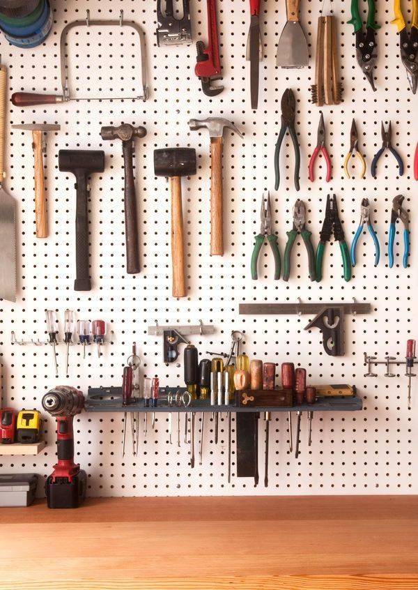 Tool storage on wall-mounted pegboard.