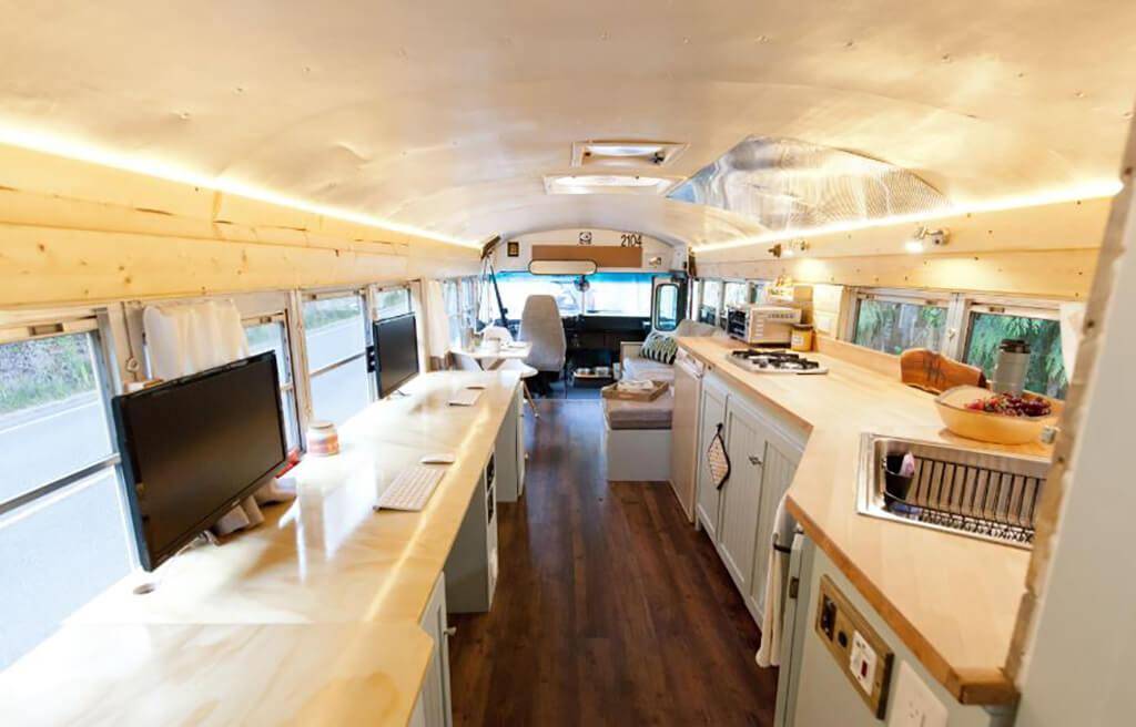 Office and kitchen inside a bus.