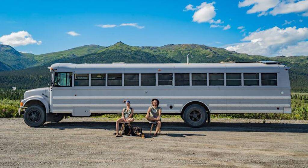 Couple sitting in front of the finished bus.