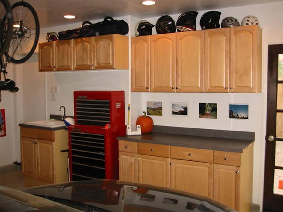 Kitchen cabinets in garage used for storage.