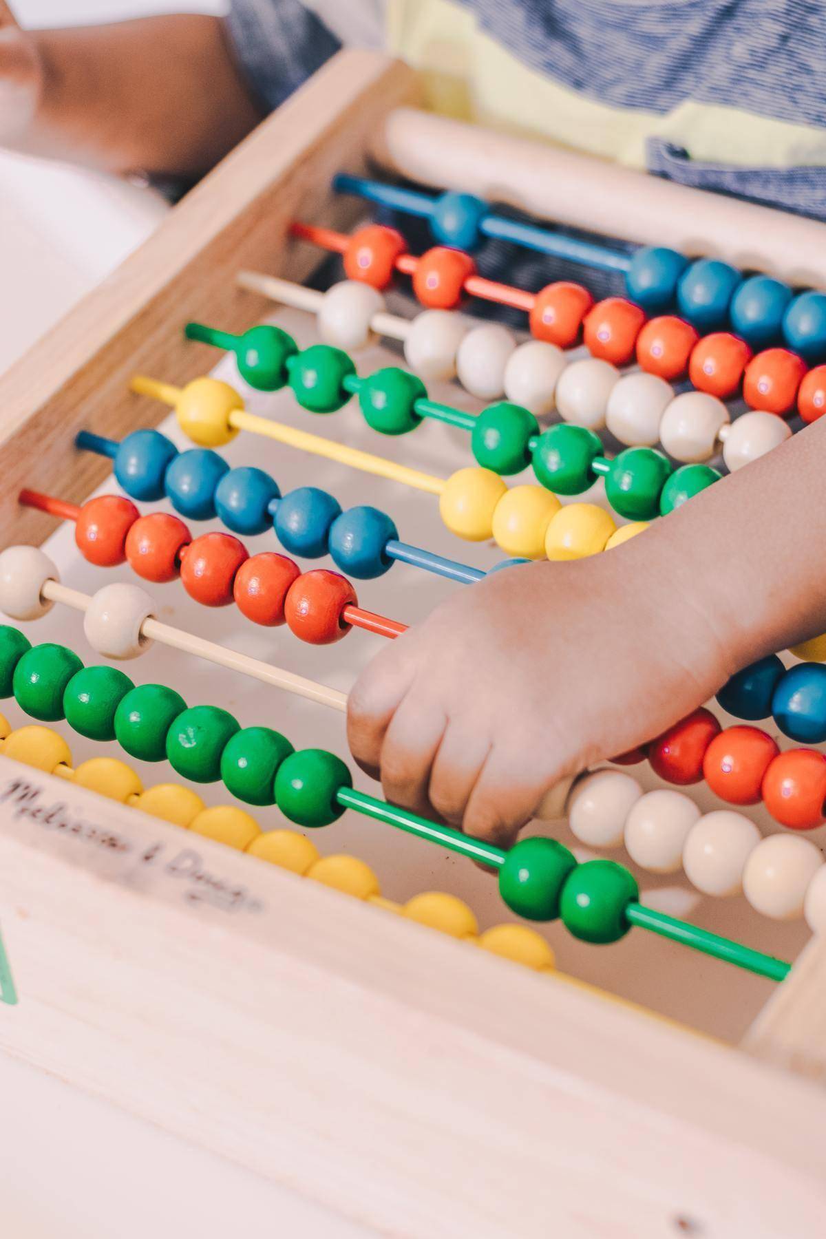 Kid playing with counting beads